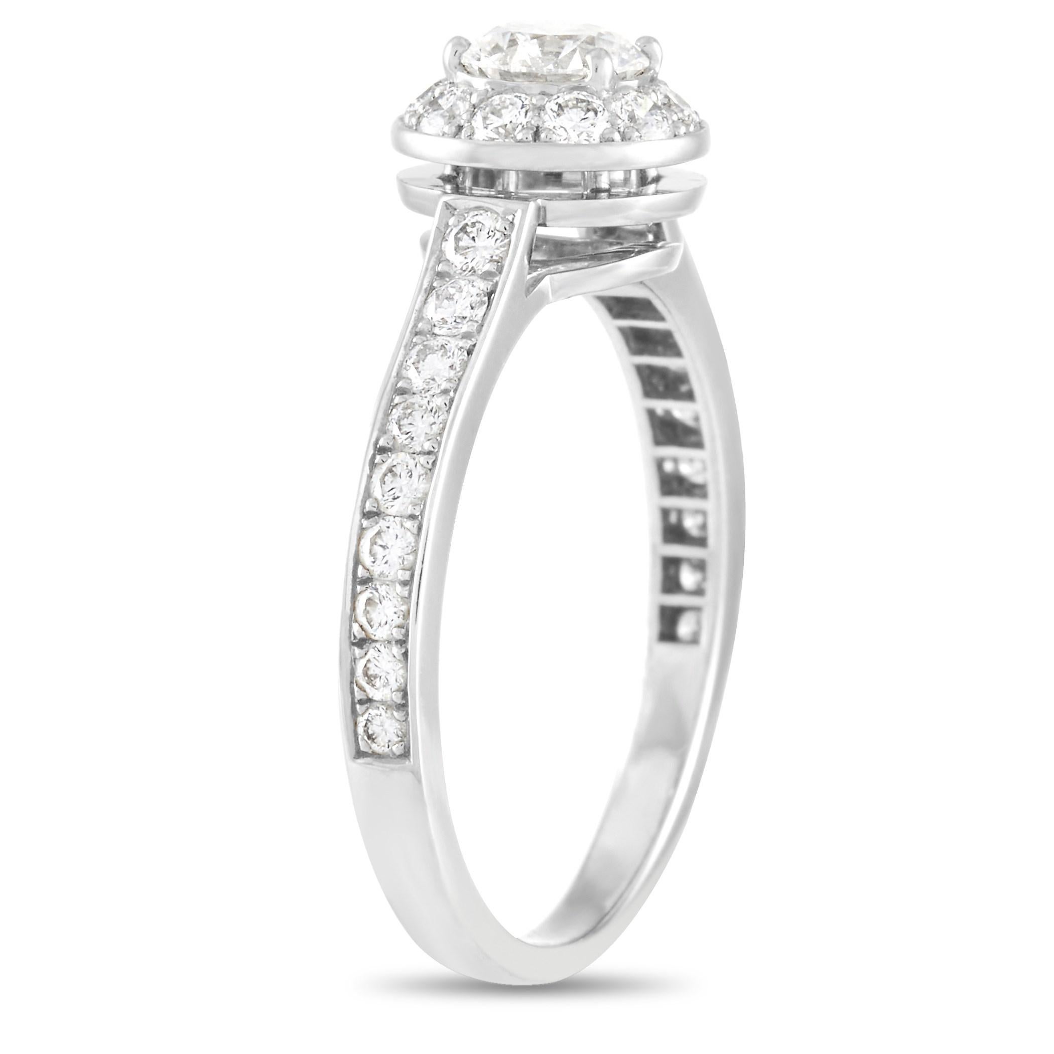 This beautiful platinum engagement ring is sure to win her heart. Designed with a romantic silhouette and a captivating vintage charm, here is a slender 2mm platinum band adorned with a 0.40 ct haloed diamond centerpiece. Adding more sparkle are