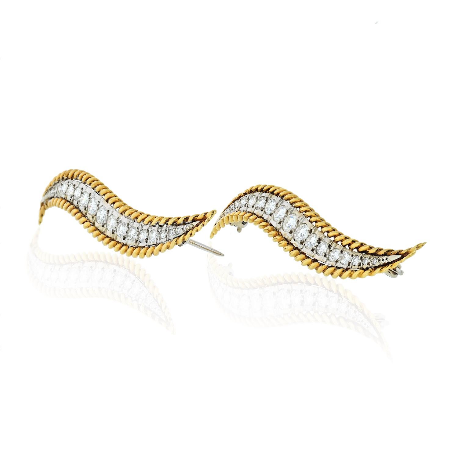 This is a beautiful Van Cleef & Arpels platinum and yellow gold brooch set comprised of two stunning brooches featuring full-cut diamonds approx. 2.50cts in diamond weight, rope twist accents. 

Each brooch is about 2.25inches long and 8.4mm wide at