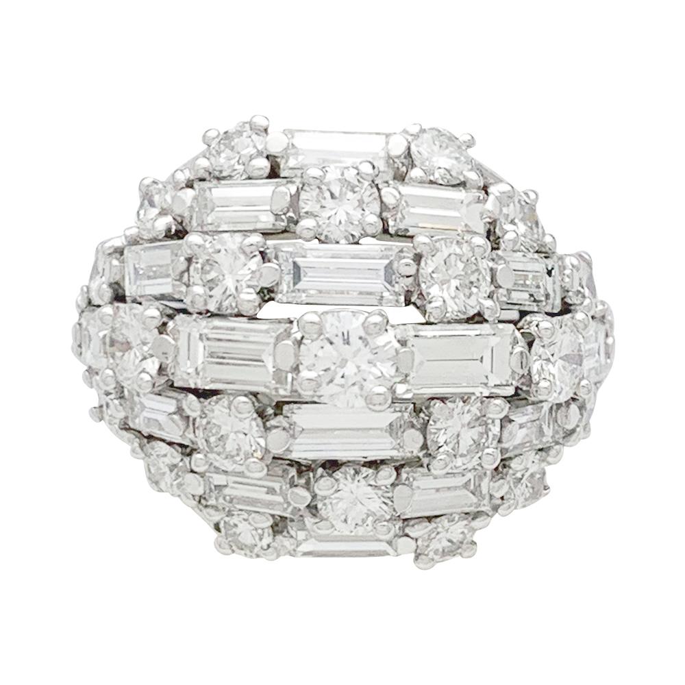 A platinum Van Cleef & Arpels dome ring, entirely set with baguette and brilliant cut diamonds. 
White gold sizing spring inside the ring.
Signed and numbered, french and maker hallmarks.
Ring size : 5 might be two sizes bigger without the