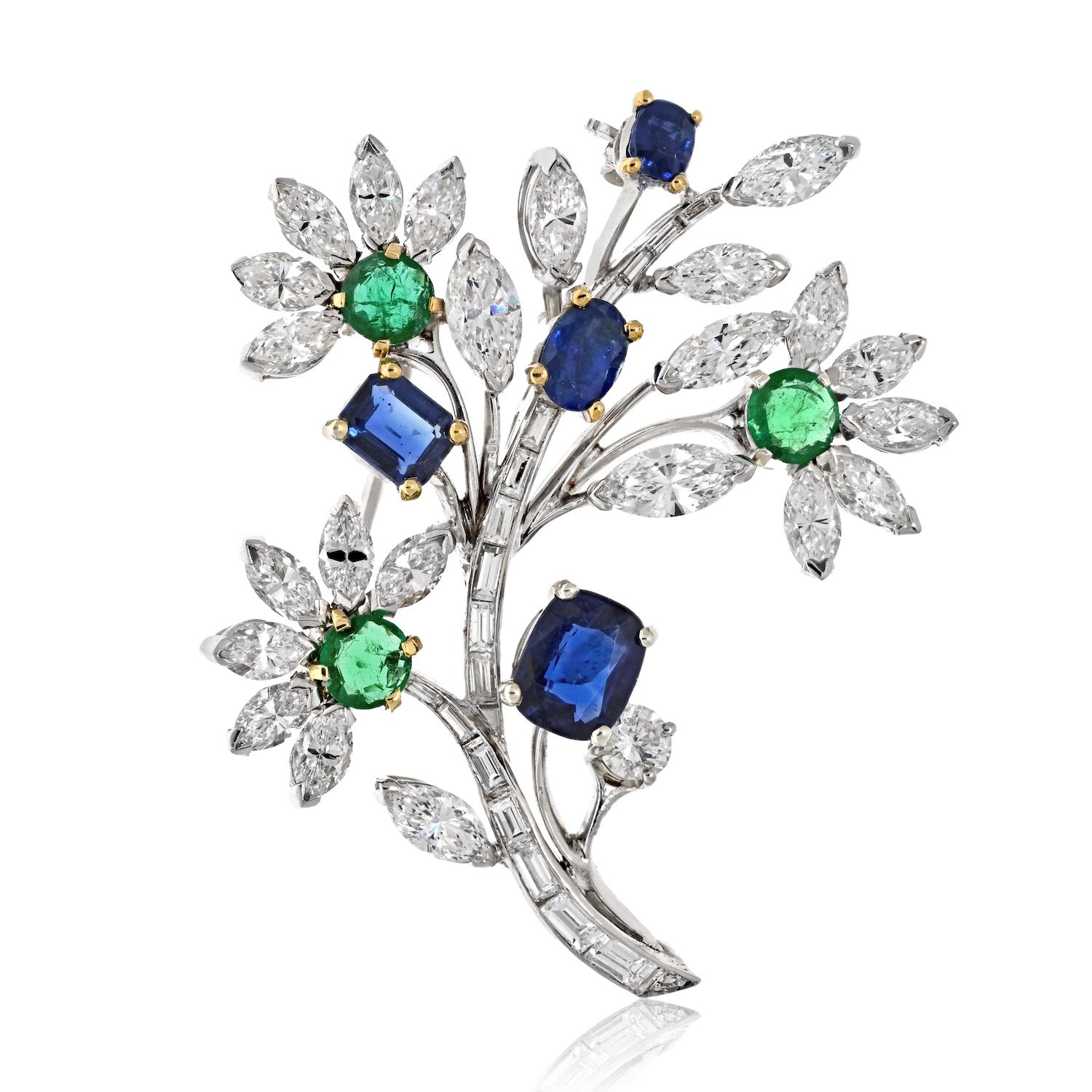 This signed and numbered Van Cleef & Arpels platinum brooch is truly a work of art. The floral motif is beautifully crafted and adorned with diamonds, emeralds, and sapphires. What makes this brooch truly special is that all four of the sapphires