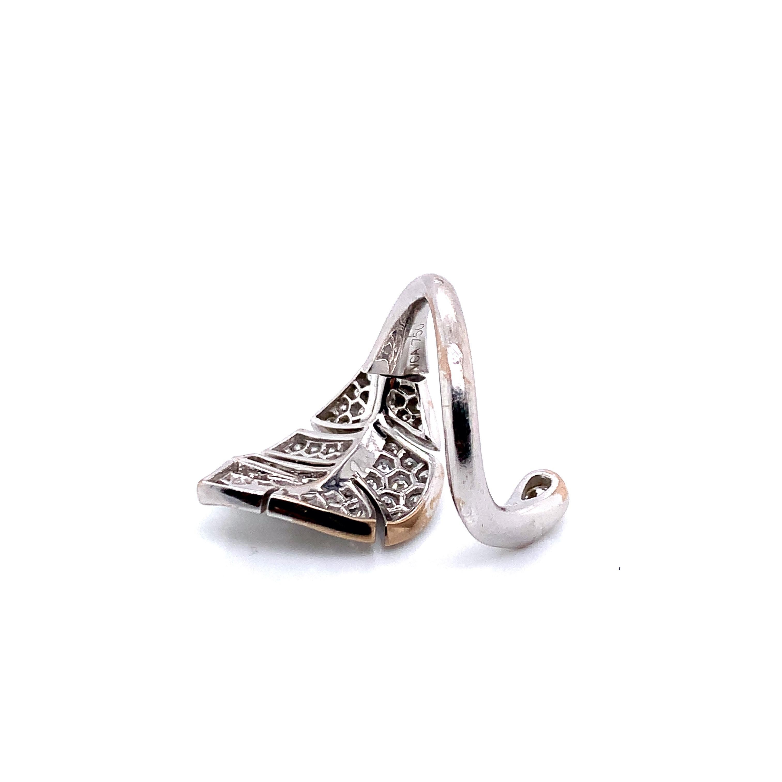 Signed Van Cleef & Arpels (VCA), this white gold ring has a moving leaf motif. Total weight is 9.9 grams. 