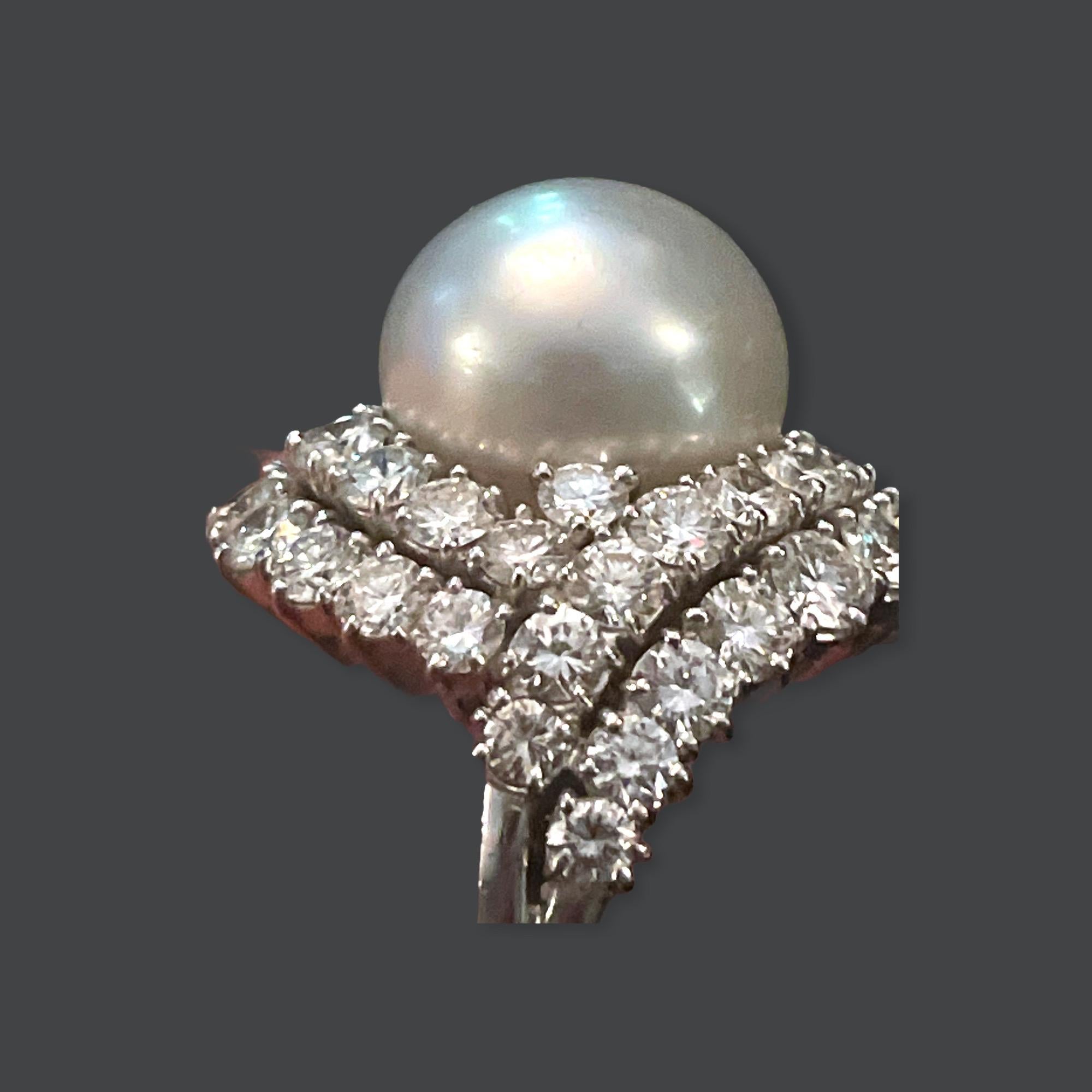 Van Cleef and Arpels Platinum and Diamond Ring featuring a very fine white South Sea Tahitian Pearl measuring approximately 13.3mm surrounded by 2 rows of 48 Round Brilliant Cut Diamonds approximately 5.30 carats in total. The ring is signed 