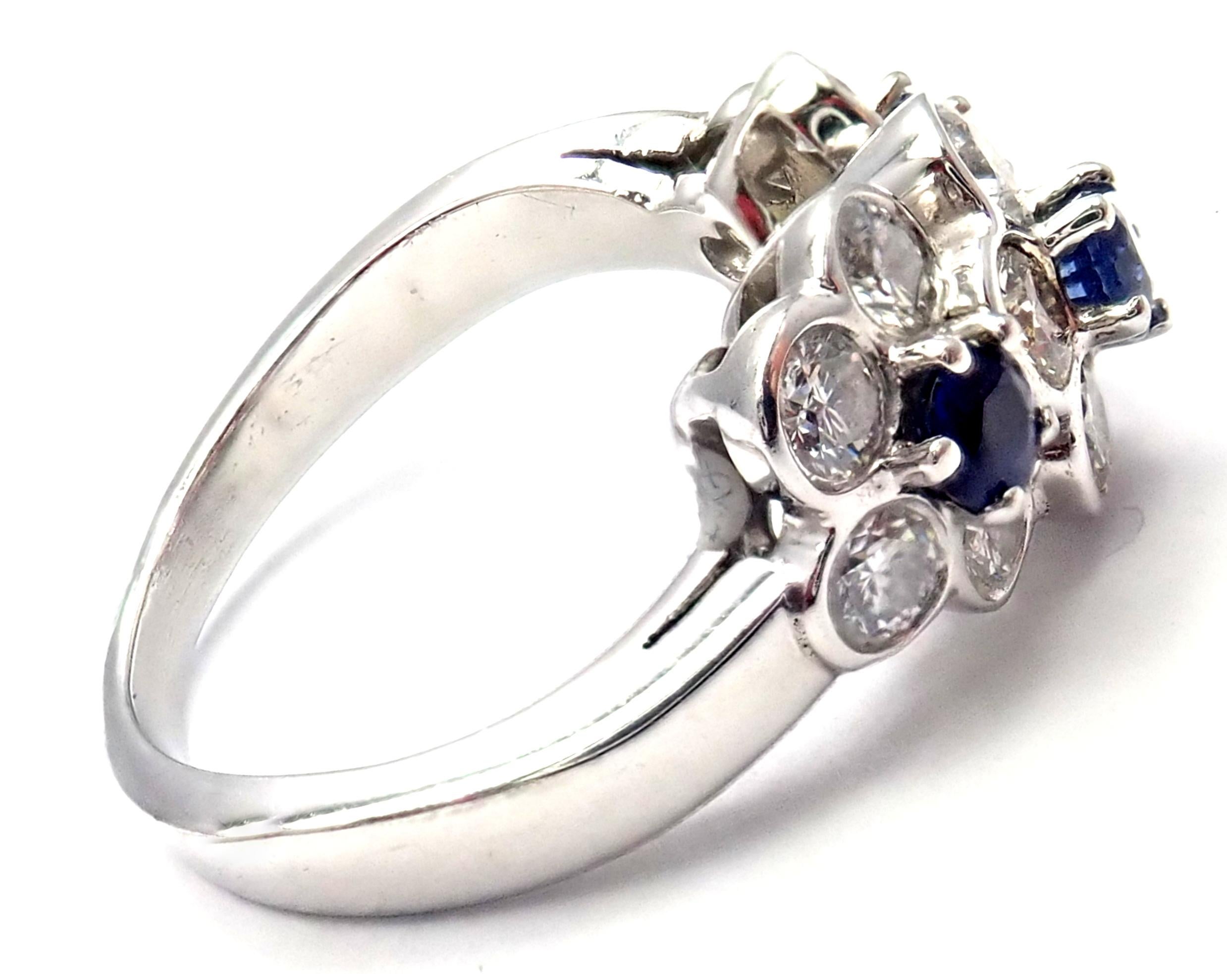 Platinum Diamond & Sapphire Fleurette Flower Ring by Van Cleef & Arpels. 
With 13 round brilliant cut diamond VVS1 clarity, E color total weight approx. .65ct
3 round sapphires total weight approx. .30ct
Details:
Size: 4
Width: 9.5mm
Weight: 7