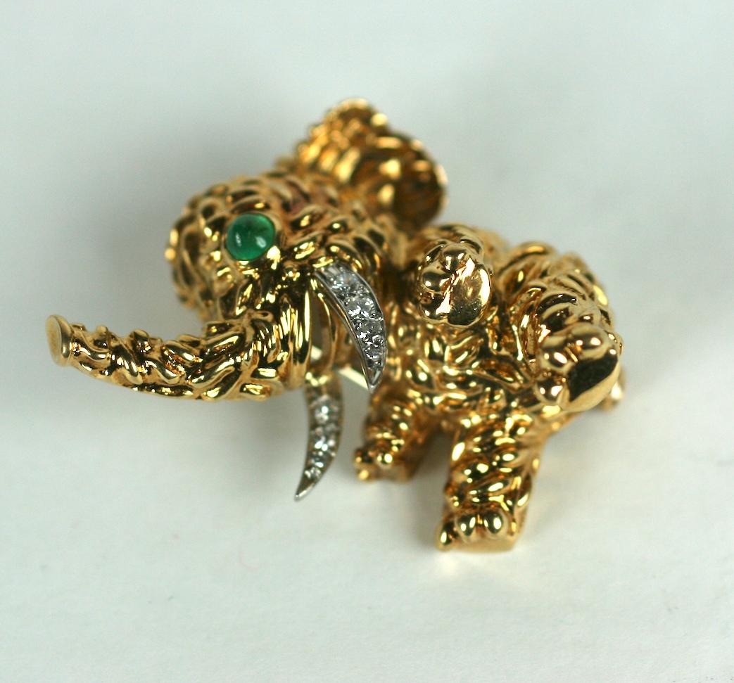 Charming Van Cleef & Arpels Playful Toy Elephant Clip rendered in 18k textured gold with diamond pave accented tusks and cabochon emerald cabochon eye. Clip back fittings with safety plunger.
Signed VCA with French hallmarks throughout. France