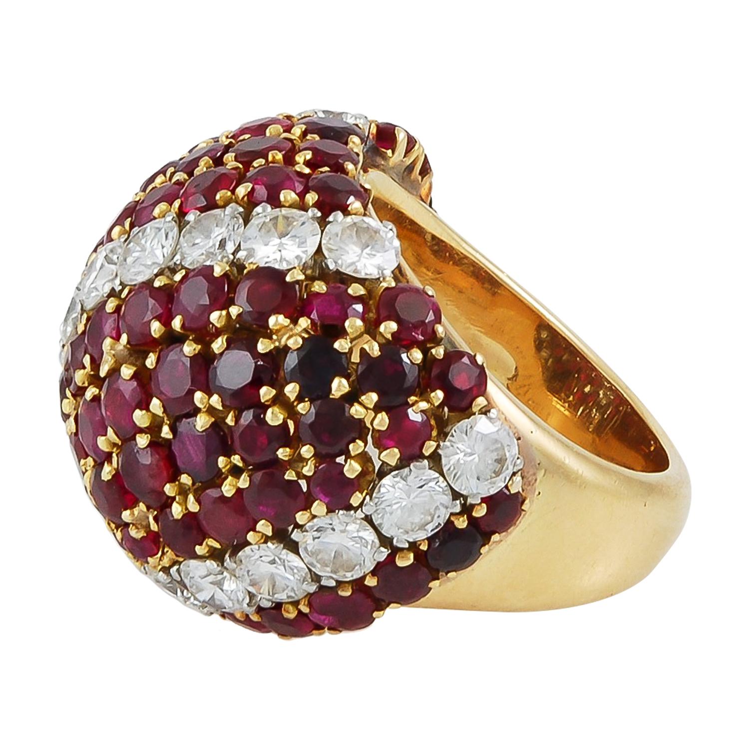 A bejeweled mid-century retro ring by Van Cleef & Arpels exhibiting a design emblematic of the Maison: the domed voluminous forms of ‘Pelouse’ (in some books this look is also referred to as ‘Lawn’). Faceted gemstones in a continuous bombé shape are