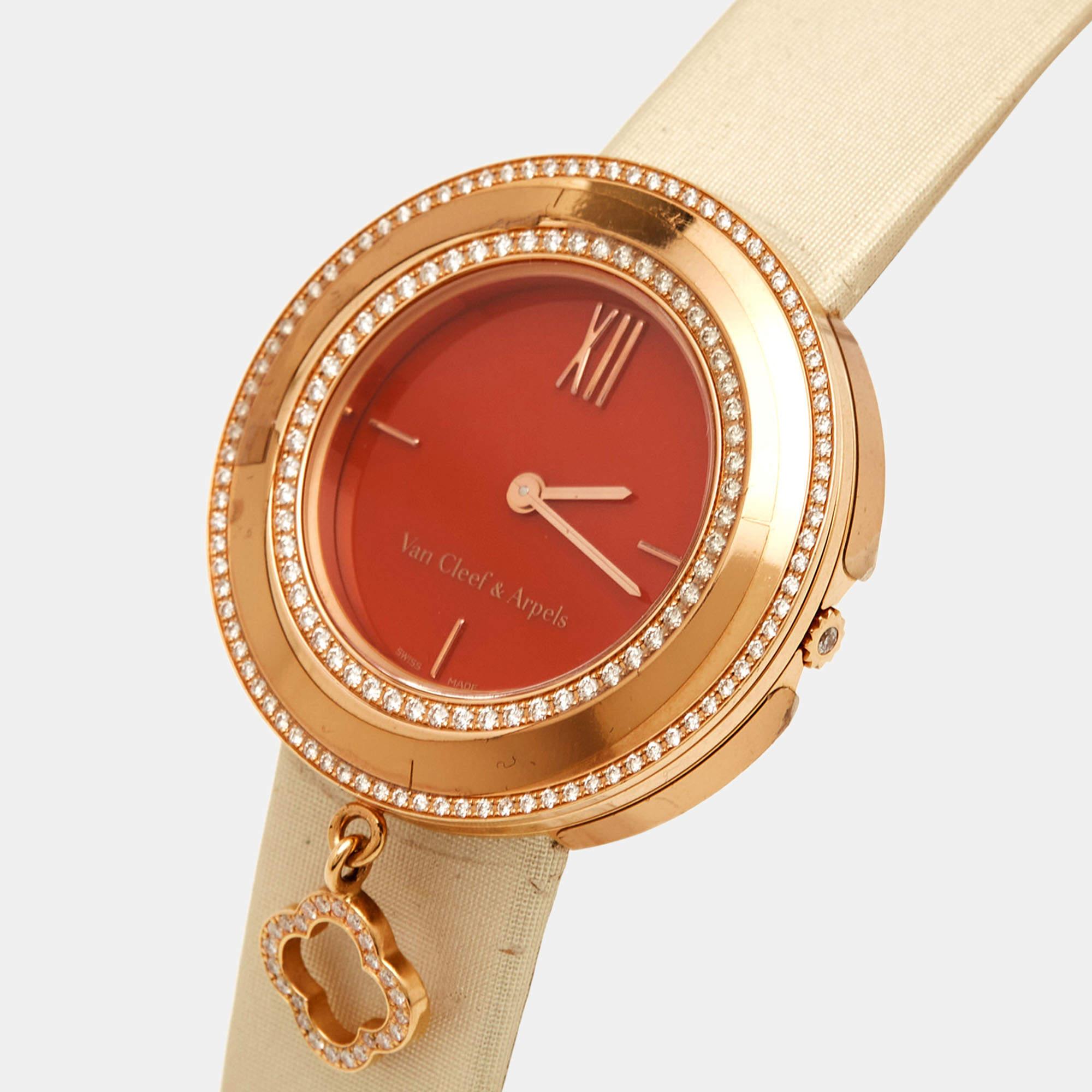 Van Cleef & Arpels continues its legacy of presenting us with wondrous works of art to wear and treasure forever. An 18k rose gold round case is centered with a red carnelian dial, tipped with two rows of diamonds, and a dangling diamond-set clover