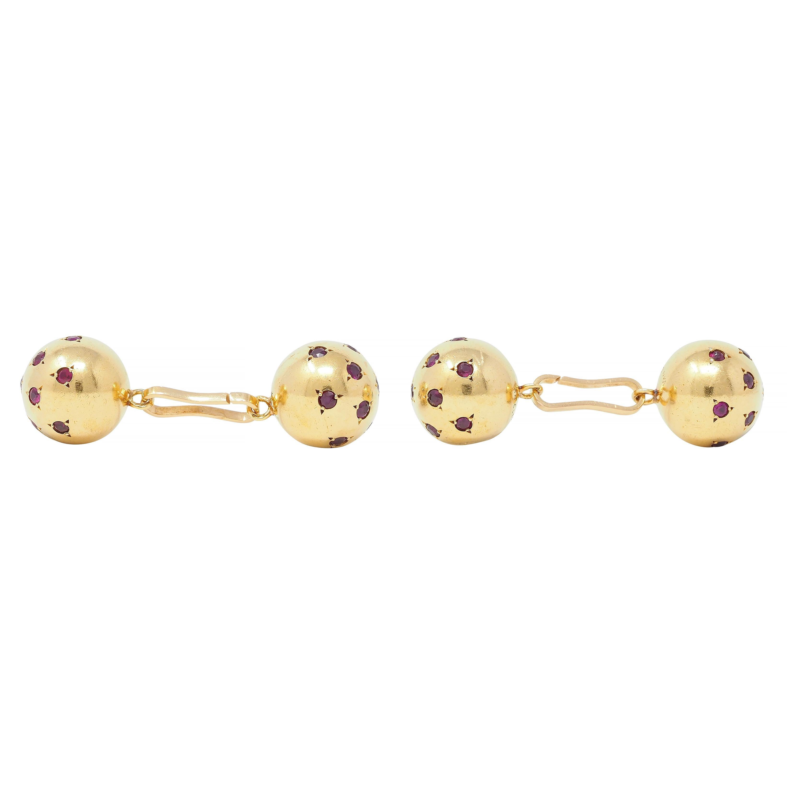 Designed as link-style cufflinks terminating with gold spheres
Flush set throughout with round cut rubies 
Weighing approximately 2.20 carats total
Transparent medium purplish red in color 
Tested as 18 karat gold
Numbered and fully signed with