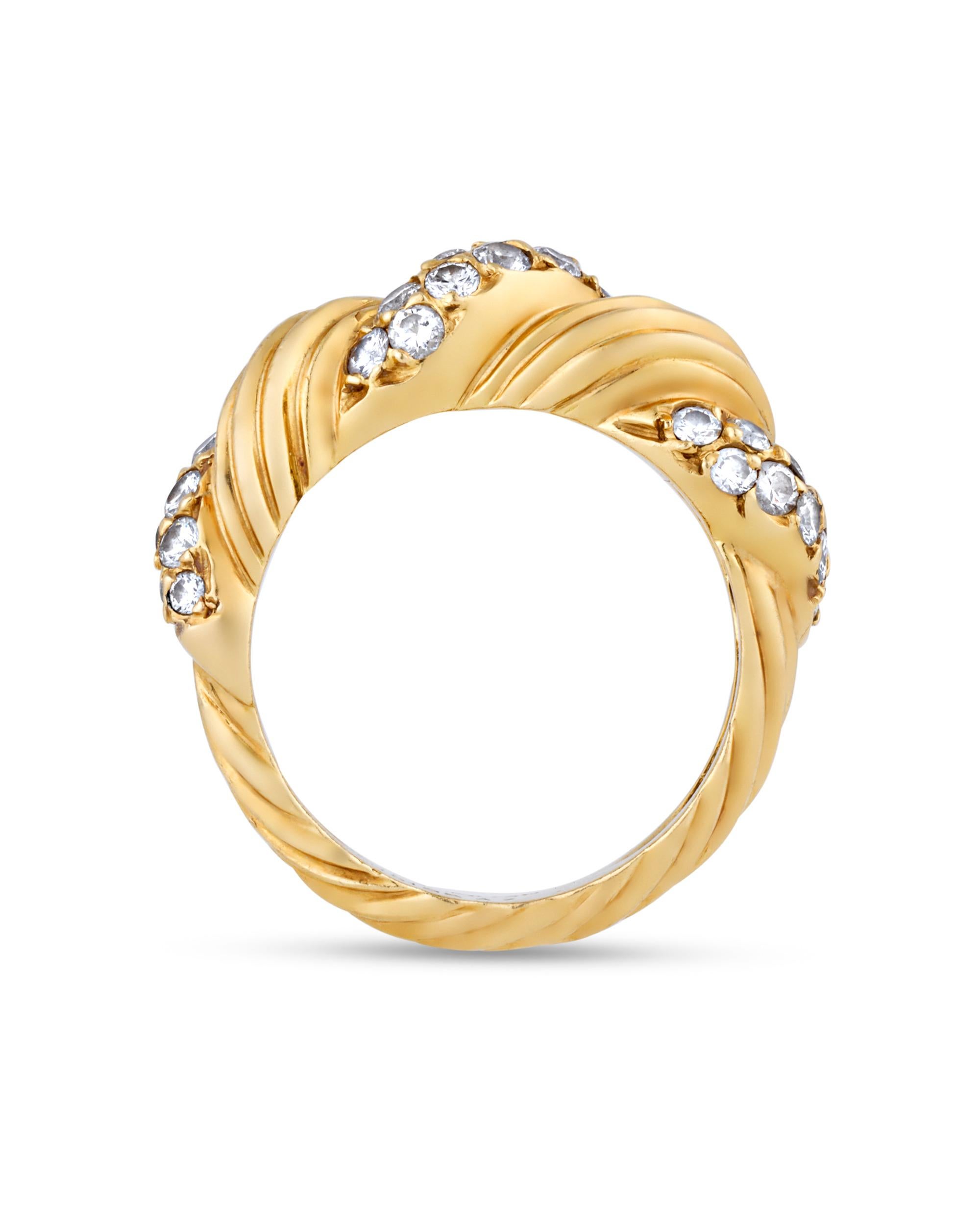 Combining exquisite gems and daring design, this ring by Van Cleef & Arpels is a standout example of retro cocktail jewelry. The bold 18K yellow gold form features a twisting design accented by an array of pavé-set white diamonds. Radiant and