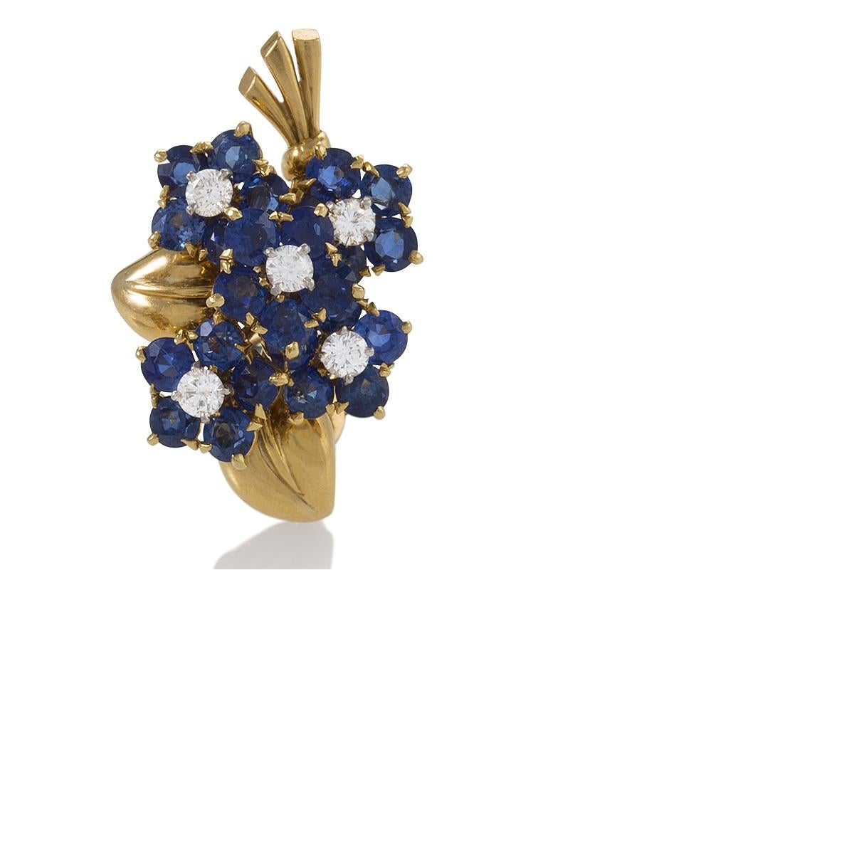  pair of French Retro 18 karat gold bouquet earrings with diamonds and sapphires by Van Cleef & Arpels. Each designed as a cluster of sapphire blossoms centering diamond pistils amidst leaves and foliage, set with 10 round brilliant-cut diamonds