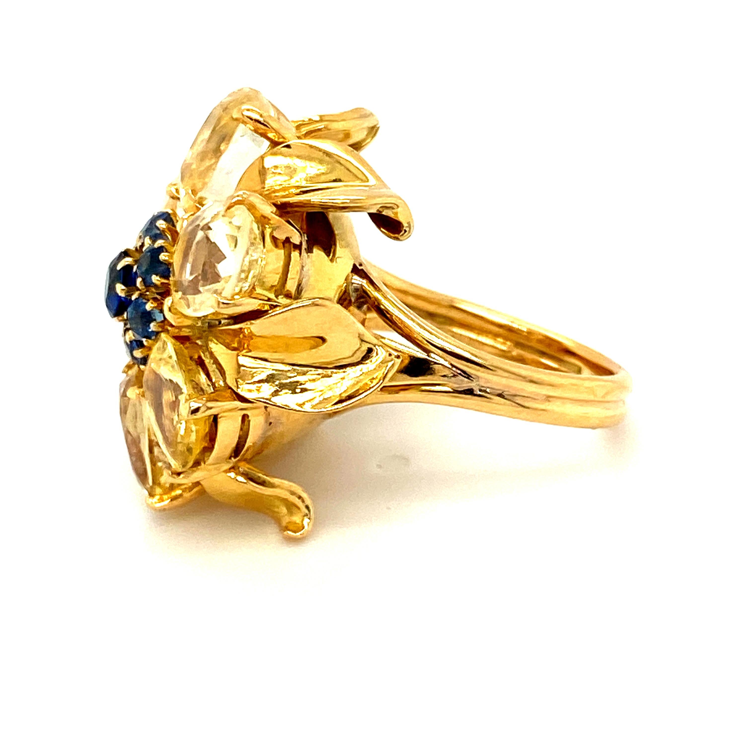 A yellow and blue sapphire ring from Van Cleef & Arpels in a classic, recognizable 1940s floral style most often seen in Van Cleef brooches and less often in rings or other types of jewelry.  The 6 yellow sapphires weigh an estimated 9.3cts of a