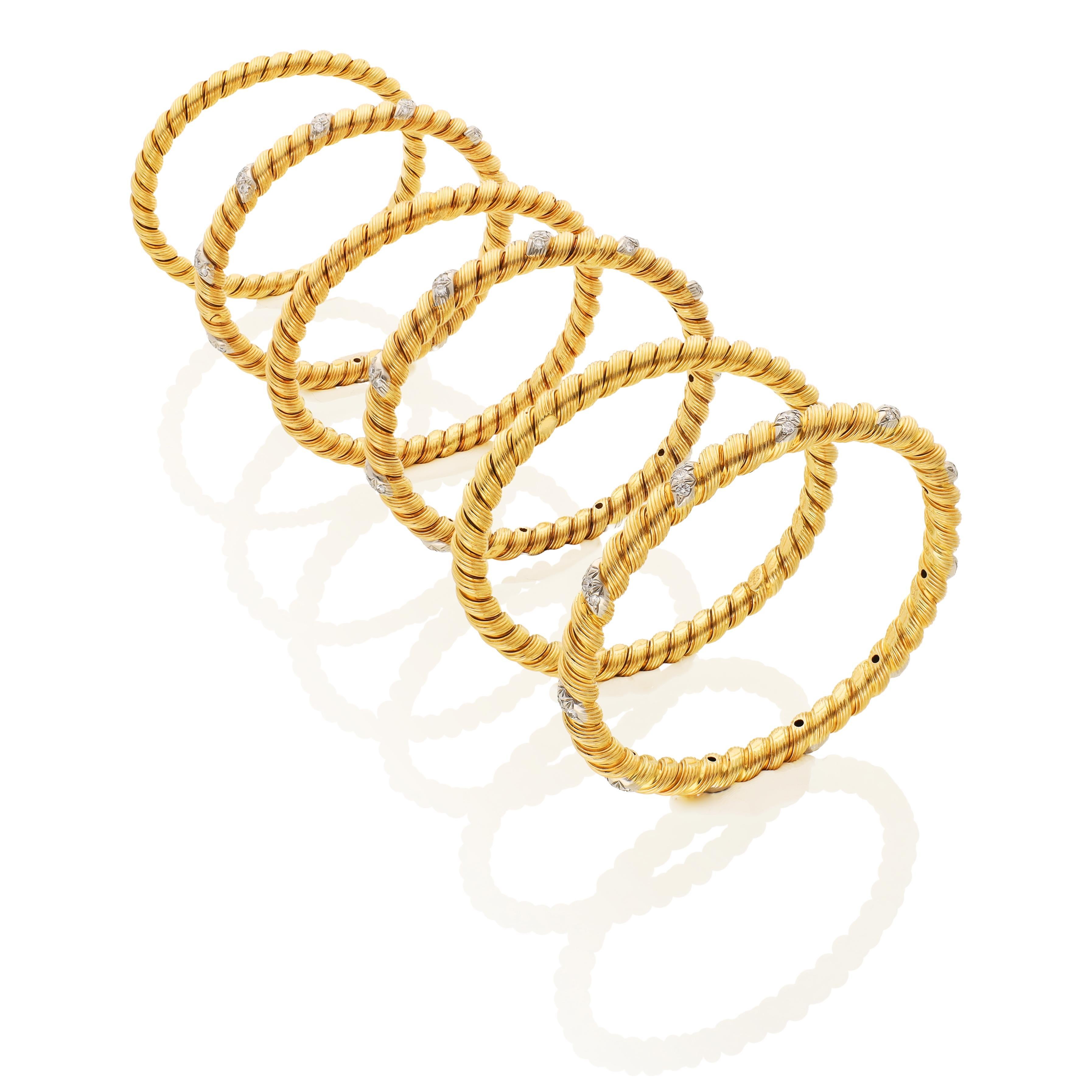 Set of six bangles featuring a rope twist design. The set includes three bangles crafted in 18K yellow gold and three bangles made from 18K yellow gold and accented with round brilliant-cut diamonds. 

Approximate inner circumference - 6.50