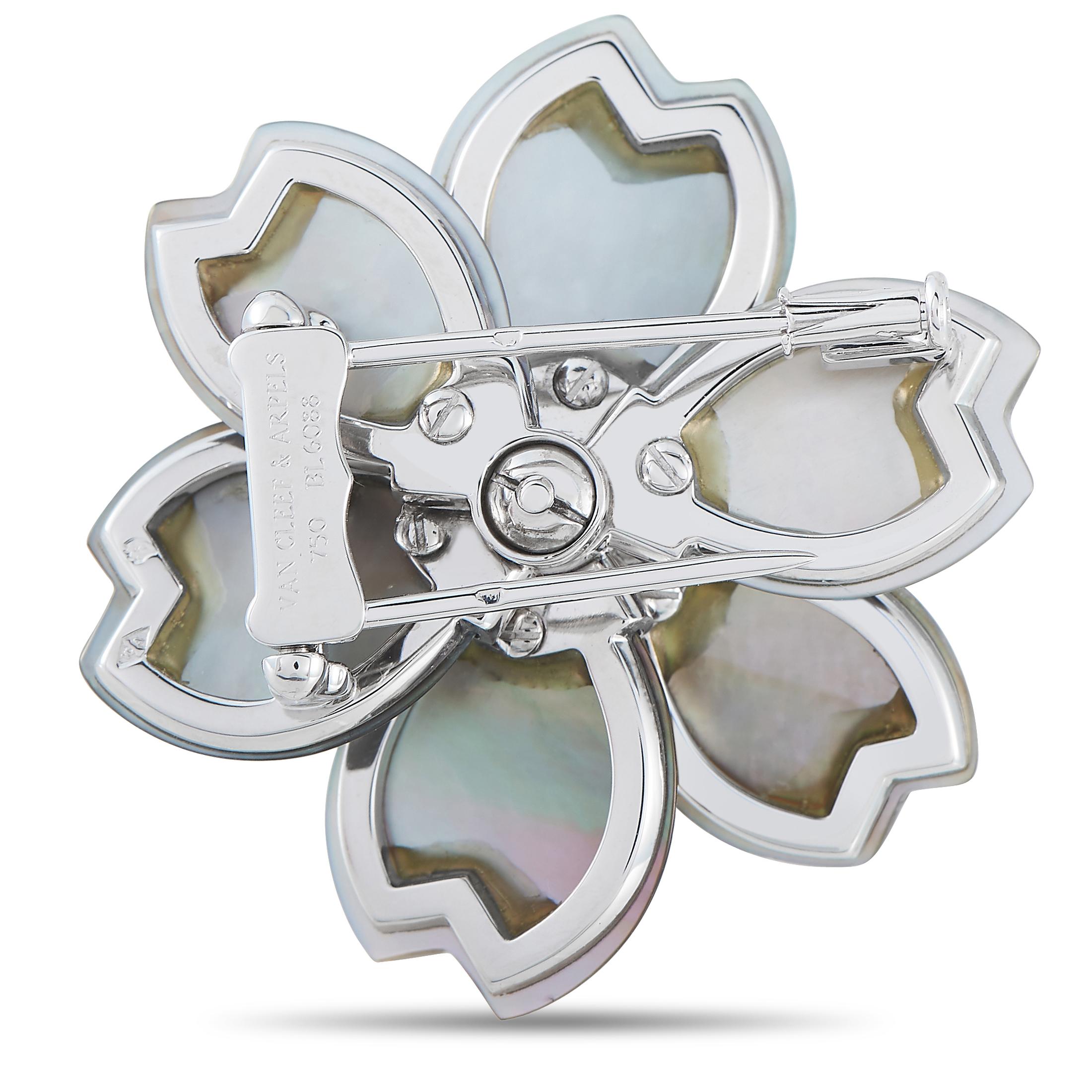 An exquisite floral brooch to polish any sophisticated ensemble. This white gold piece from Van Cleef & Arpels features six meticulously shaped petals in black Mother-of-Pearl. They surround a corolla of diamonds with white gold sunrays bursting in