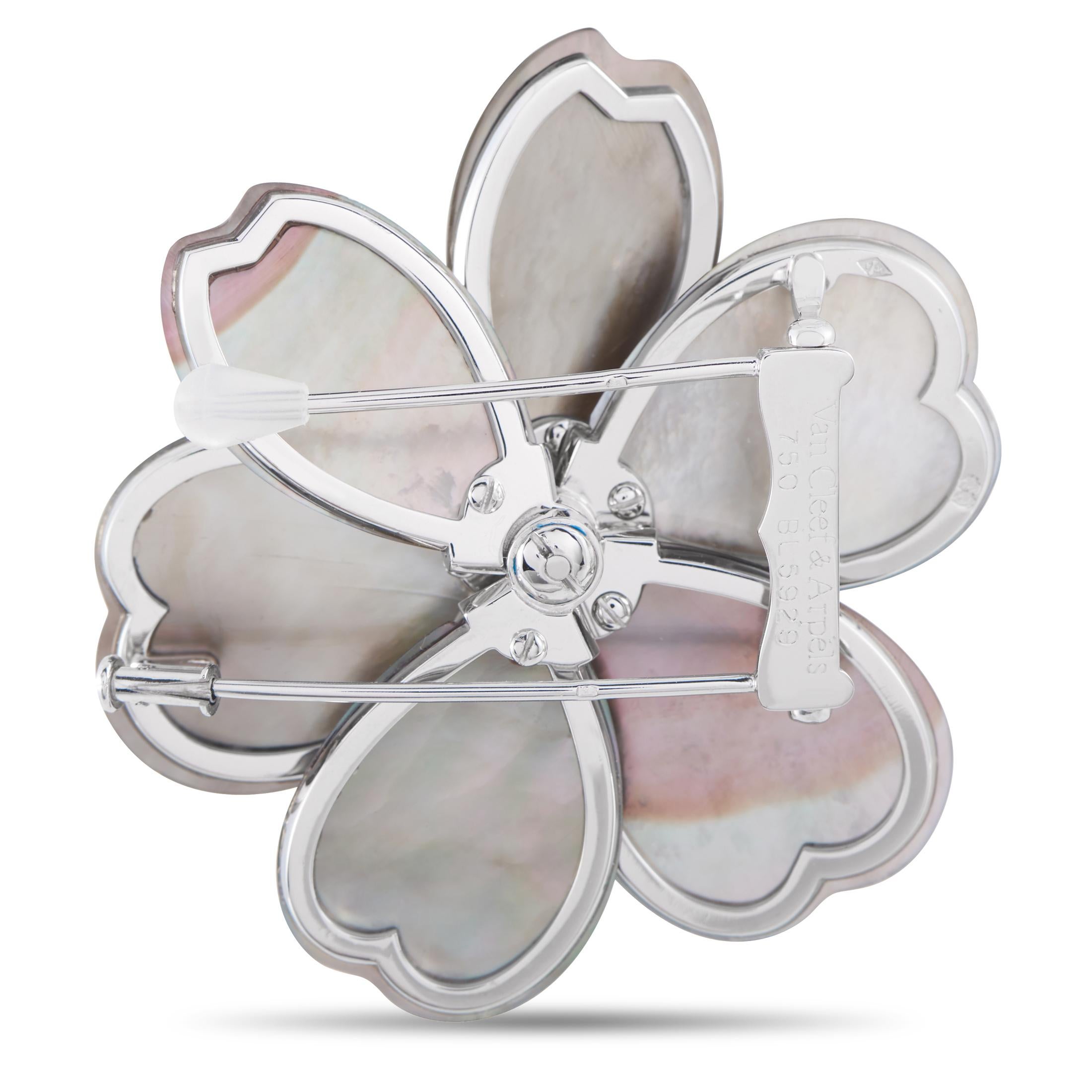 Of enduring beauty, this Van Cleef & Arpels 'Rose de Nol' brooch will perfectly complement your timeless style. The white gold brooch with double clips features a flower motif, designed with six black Mother-of-Pearl petals circling a sunray corolla