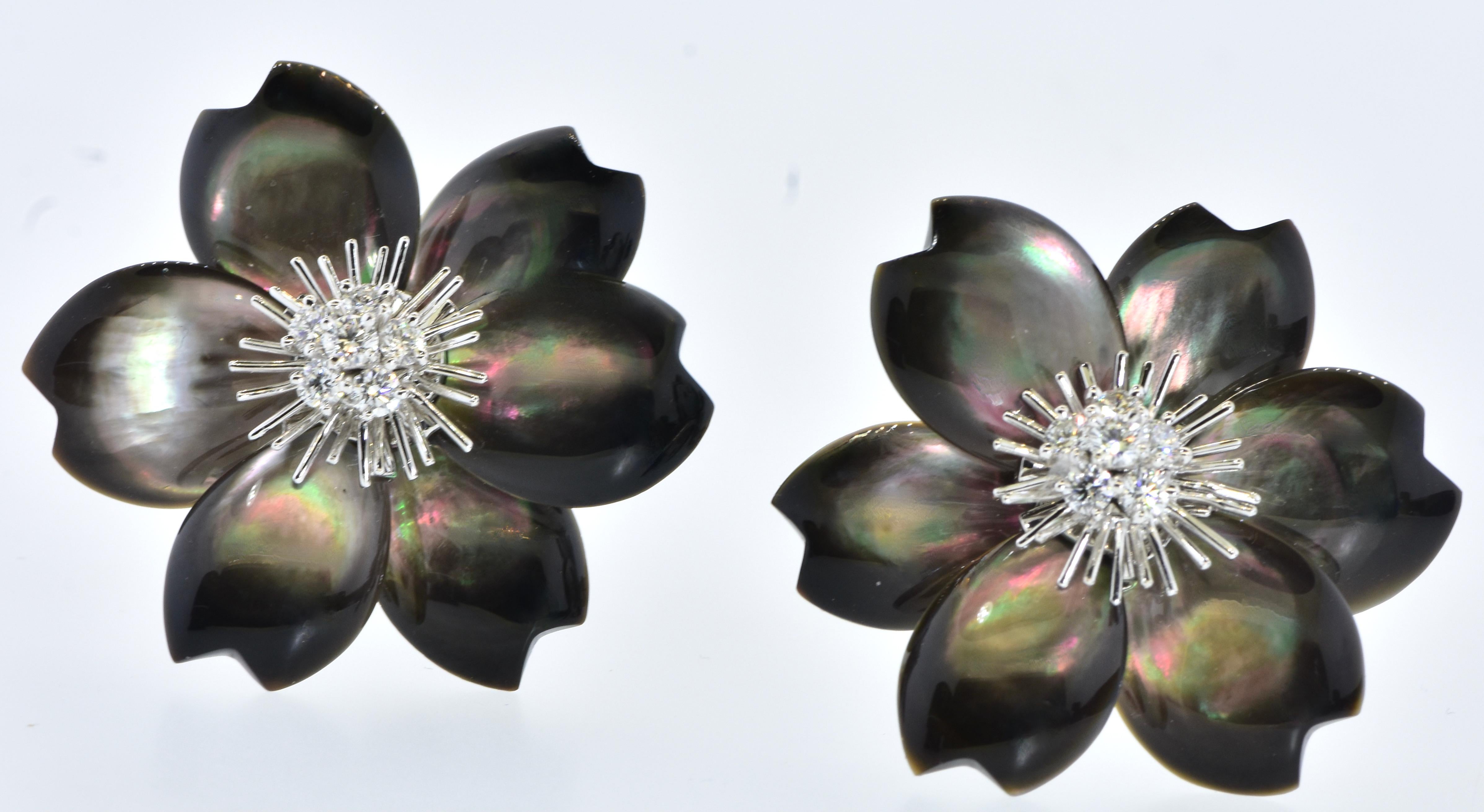 Van Cleef & Arpels Rose De Noel striking earrings with diamonds and black mother of pearl.  These vintage earrings center a bud of 7 diamonds (14 diamonds in total), surrounded by very numerous white gold pistils (more contemporary earrings have