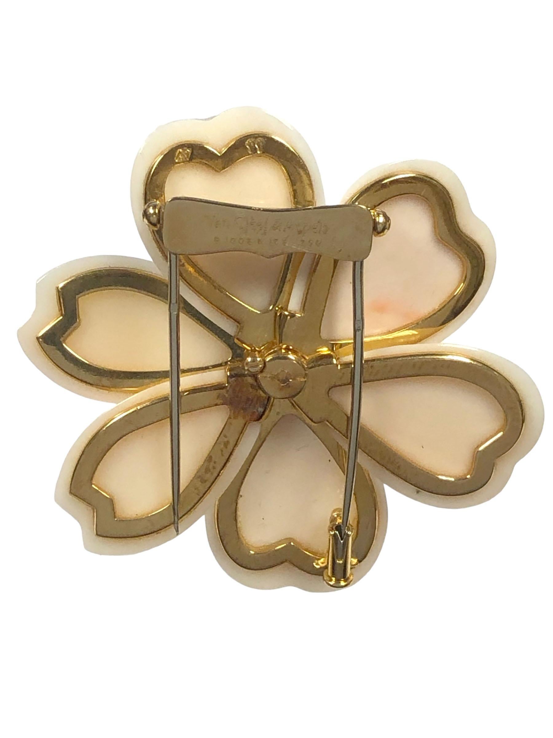 Van Cleef & Arpels Rose de Noel Collection clip Brooch, measuring 2 inches in Diameter, comprised of 6 Light Pink Coral Pedals with an 18k Yellow Gold center set with 7 Round Brilliant cut Diamonds totaling .80 Carat. having a double clip - pin
