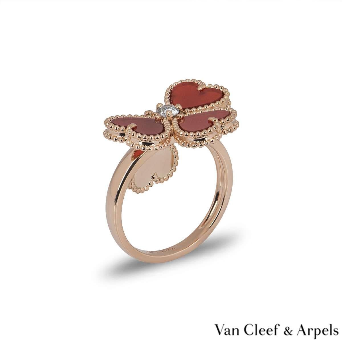An elegant 18k rose gold Sweet Alhambra effeuillage ring by Van Cleef & Arpels. The ring features 4 heart motifs, each with a beaded outer edge and a carnelian centre. There is a single round brilliant cut 0.07ct diamond in the centre, with one of