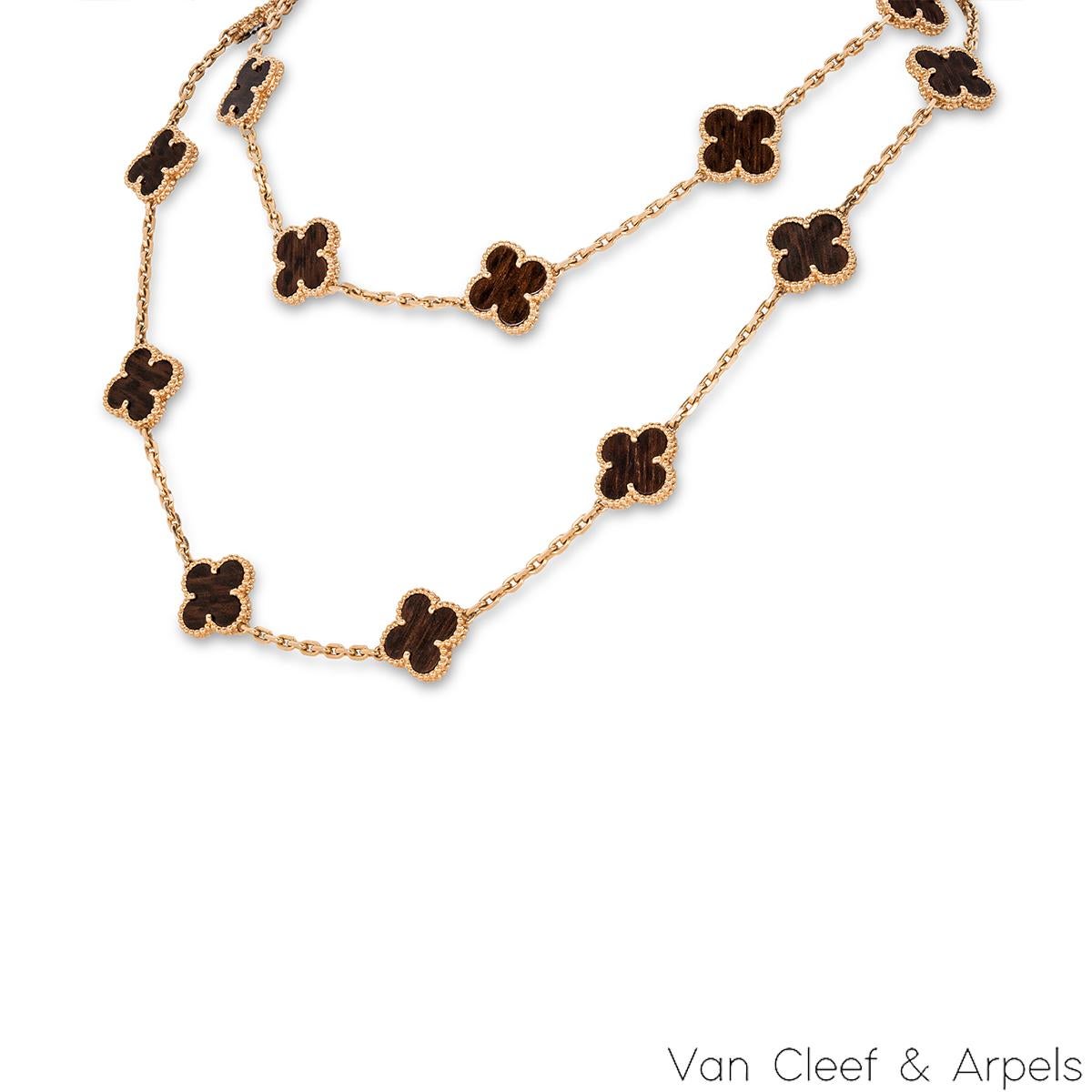 An exquisite 18k rose gold letterwood necklace by Van Cleef and Arpels from the Vintage Alhambra collection. The necklace comprises of 20 iconic 4 leaf clover motifs, each set with a beaded edge and a letterwood inlay. The necklace measures 33.8