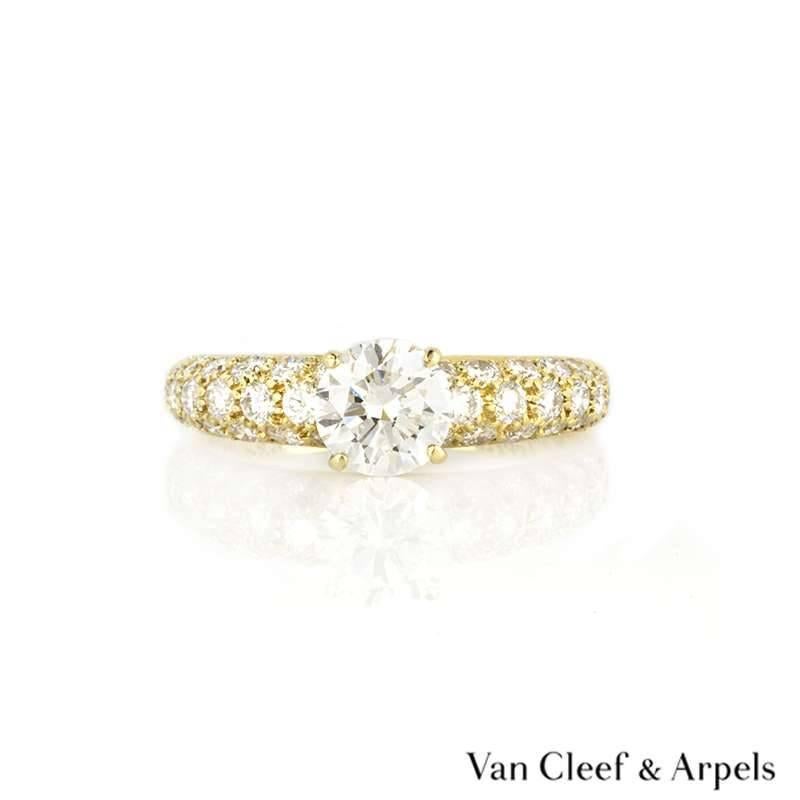 A beautiful 18k yellow gold diamond ring by Van Cleef & Arpels. The ring is set to the centre with a round brilliant cut diamond weighing approximately 0.79ct, G/H in colour and VVS2 clarity. The centre stone is accentuated by pave set diamond