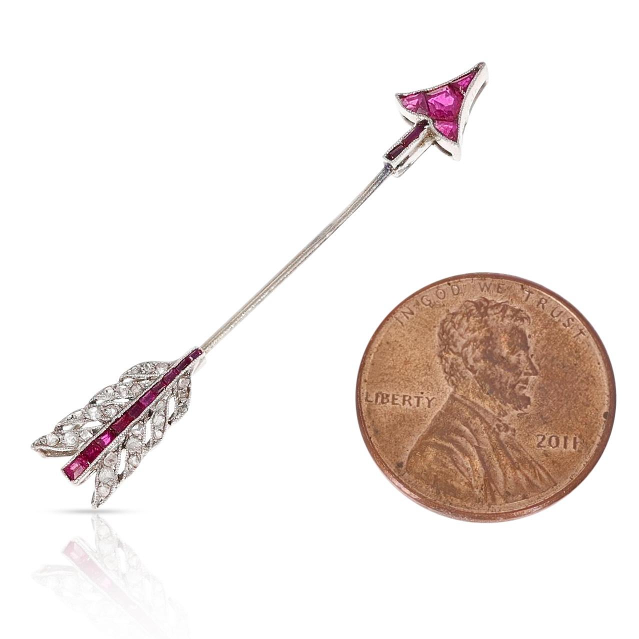A Van Cleef & Arpels Ruby and Diamond Arrow Pin made in 18 Karat Gold. The length is 4.5CM and the width is .25CM. There are 24 diamonds and the total weight is 2.16 grams. 