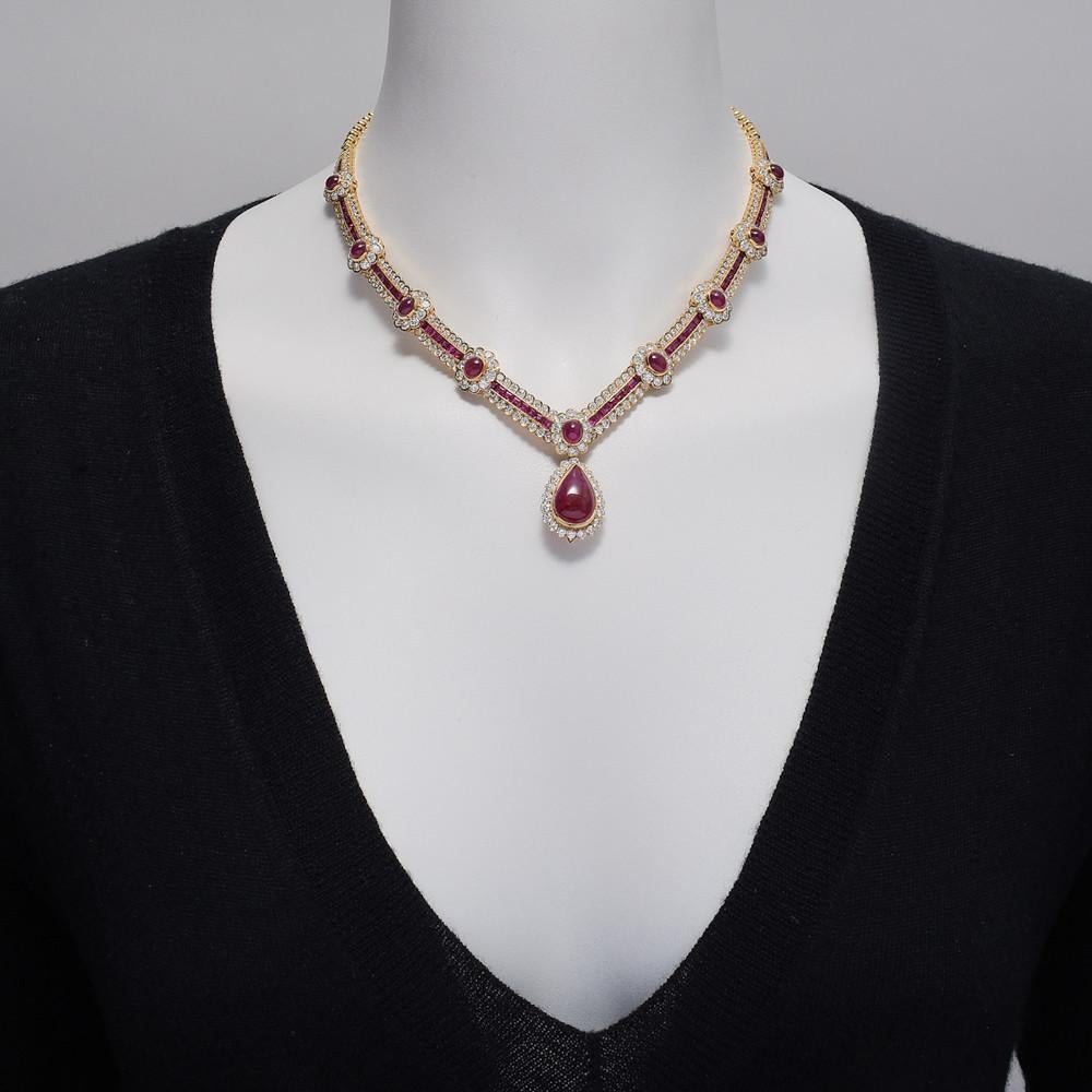 Vintage ruby and diamond necklace, the front composed of a graduated series of clusters each set with a cabochon ruby surrounded by round brilliant-cut diamonds and stationed along a calibre-cut ruby and round brilliant-cut diamond band, centering a