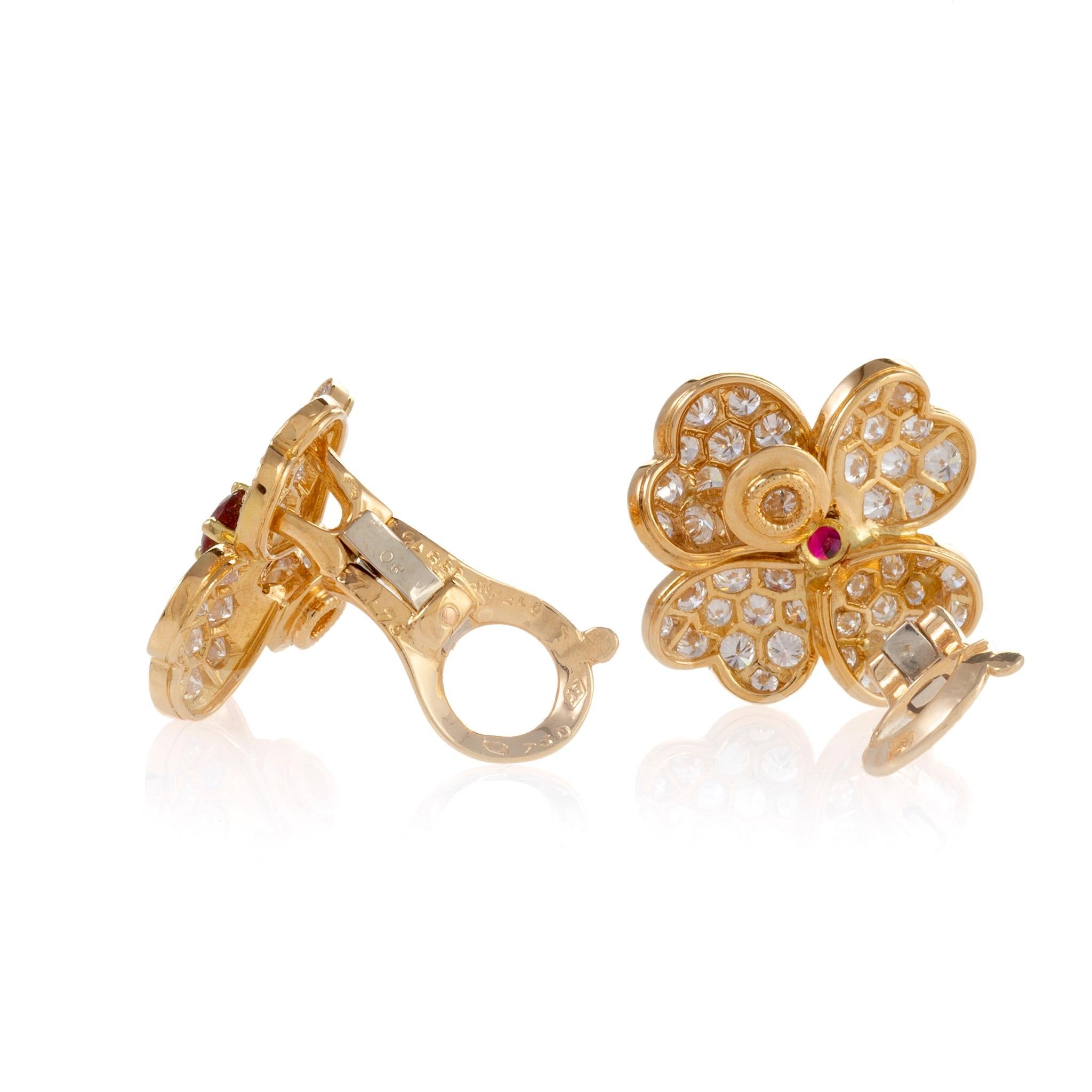 A beloved design which dates to the 1950s, these Van Cleef & Arpels “Cosmos” flower clipback earrings feature both diamonds and rubies. Each of the flowers' four heart-shaped petals is pave-set with variously-sized diamond melee, conveying a