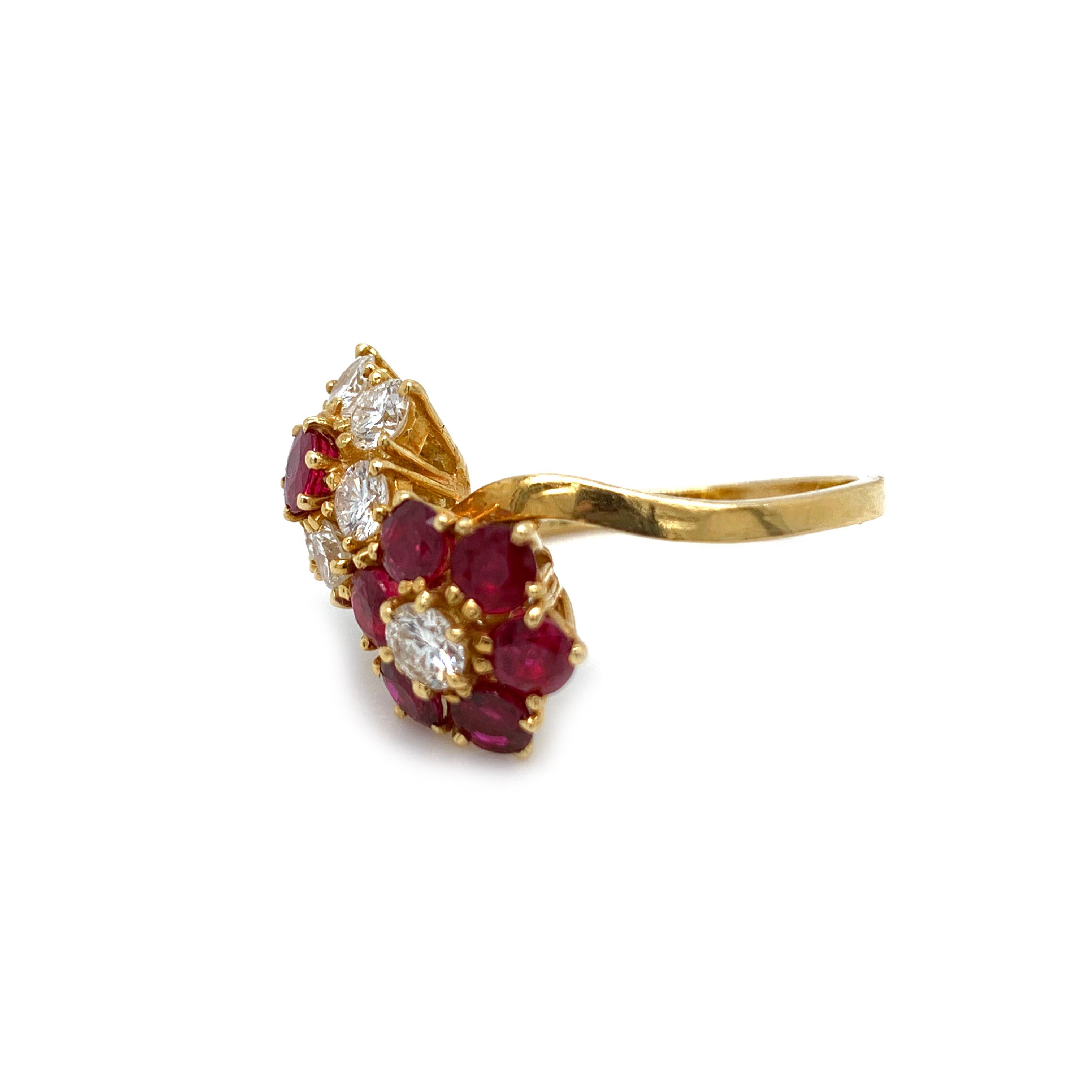 This elegant double flower ring, circa 1970, is fashioned in a rich 18kt yellow gold. The intricately designed French setting showcases two beautifully crafted flowers blooming with sparkling rich red rubies and vibrant white diamonds. Flower themed