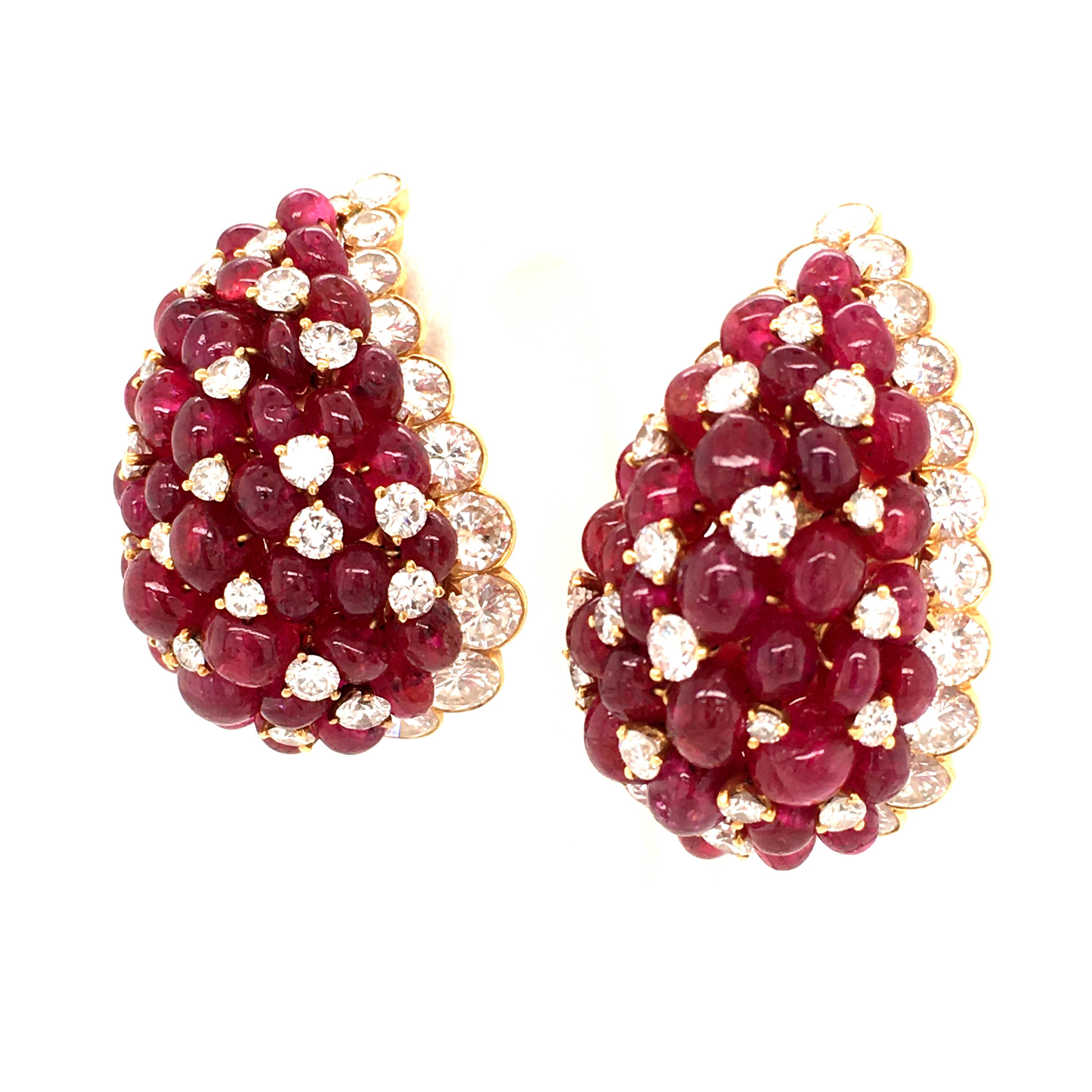 Rare Van Cleef & Arpels earclips from the 1970ies. Of bombé design, set with 64 bright red ruby beads. Ruby pattern interrupted by brilliant-cut diamonds and in framed by an entourage of round diamonds. The diamonds total up to 80 stones weighing an