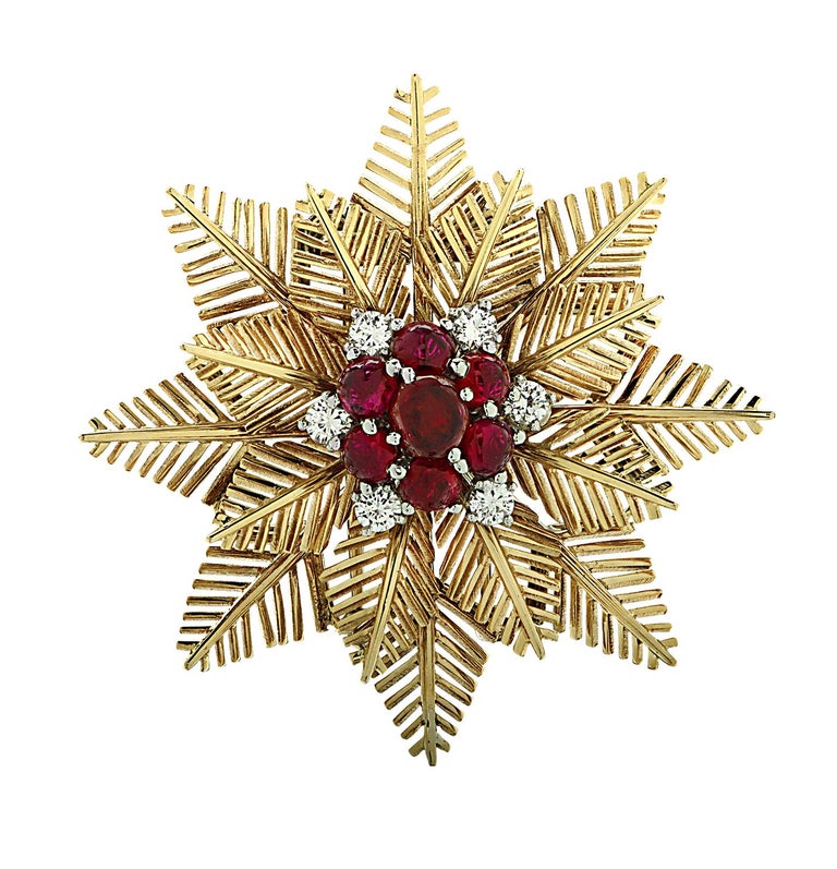 From the legendary House of Van Cleef & Arpels, this exquisite Vintage Snowflake brooch pin circa 1940, finely crafted in 18 Karat yellow gold, featuring 7 round rubies weighing approximately 2.5 carats total, adorned with 6 transitional cut