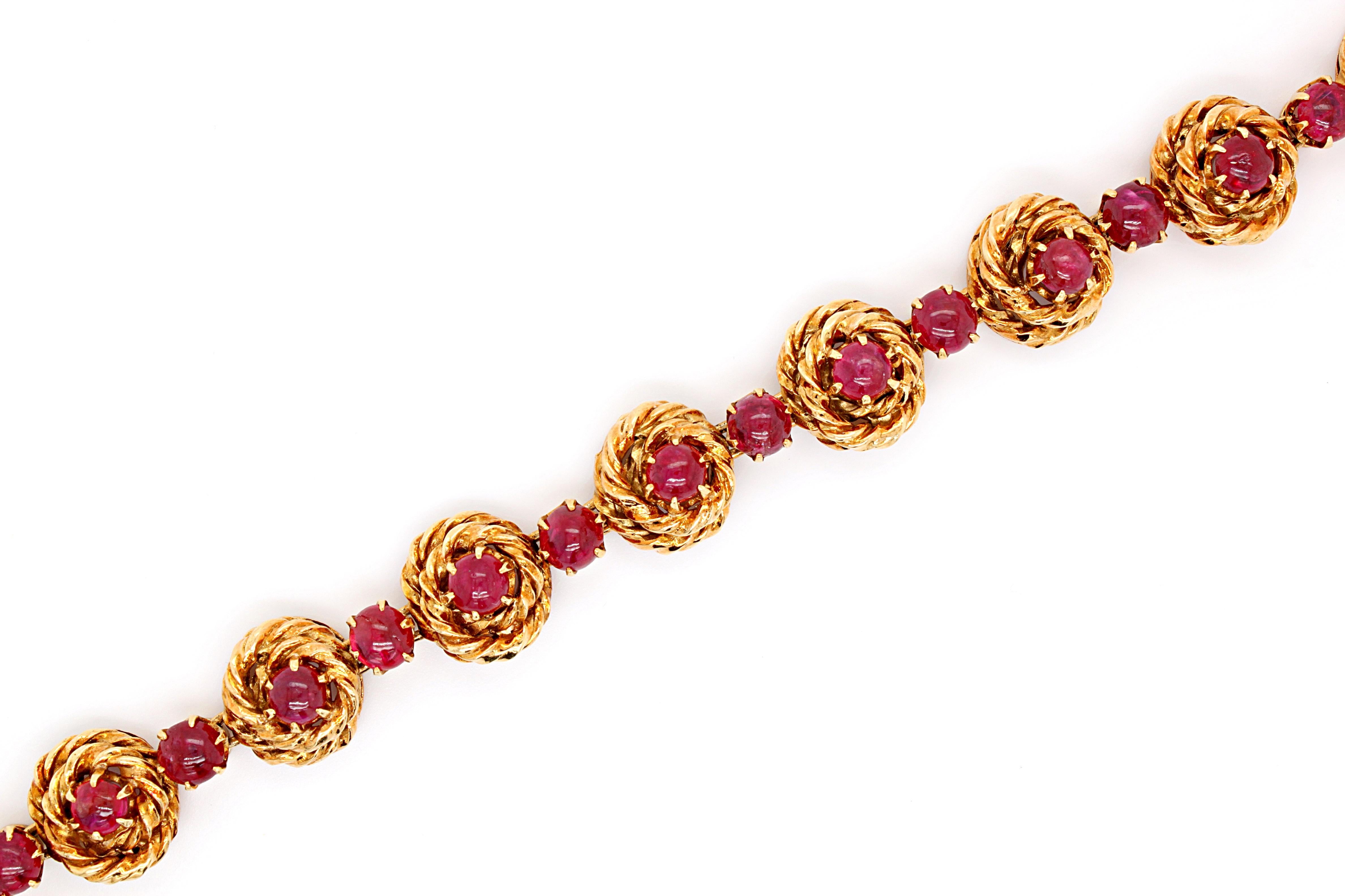 Ruby cabochon bracelet in 18k yellow gold, by Van Cleef & Arpels, France, ca. 1960s. 

The bracelet has 22 interlinking parts, all freely moving and flexible. The alternating larger links in the bracelet are intricately designed like a nest. 
Each