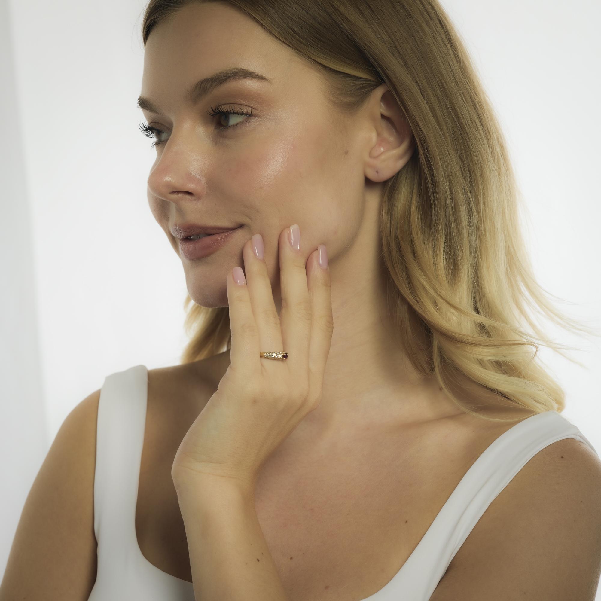 This vintage Van Cleef & Arpels ring from the 1990’s features a .40-carat round cut ruby, its vivid red hue framed by thirty round brilliant cut diamonds totaling .80 carats in exceptional D-E color and VS clarity. Crafted in radiant 18k yellow gold