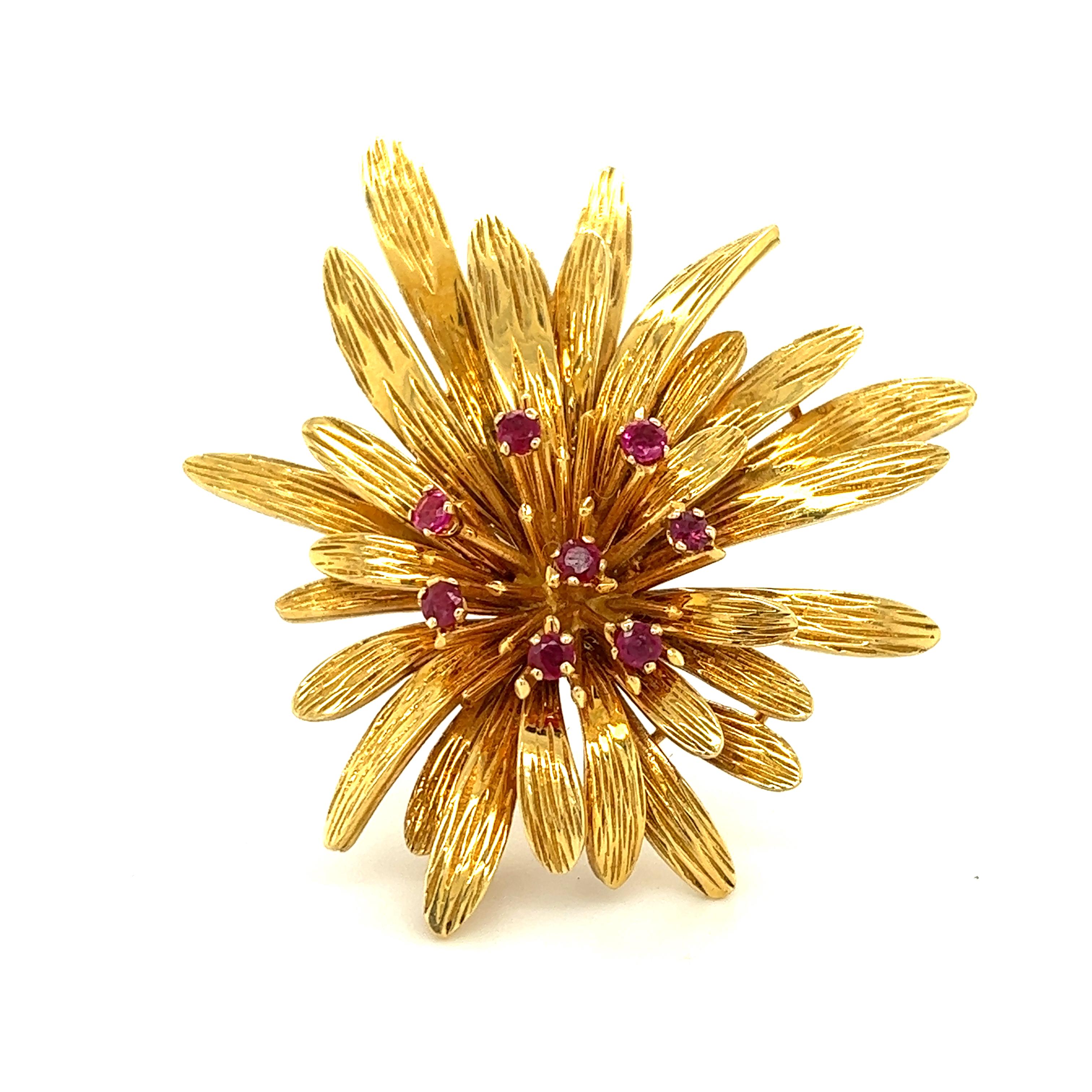    One beautiful brooch crafted by famed designer Van Cleef & Arpels. The brooch is crafted to depict a large flower as details are seen throughout. The brooch shows multiple layers of yellow gold, with fine etched details at every angle. The brooch