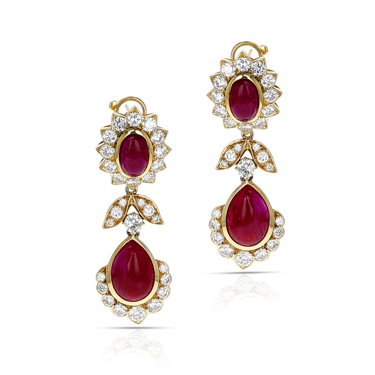 A stunning pair of Van Cleef & Arpels Ruby Oval and Pear Cabochon Dangling Earrings with Diamonds made in 18 Karat Yellow gold. The earrings have a post in the back as well. The length of the earring is 1.75 inches. The total weight of the earring
