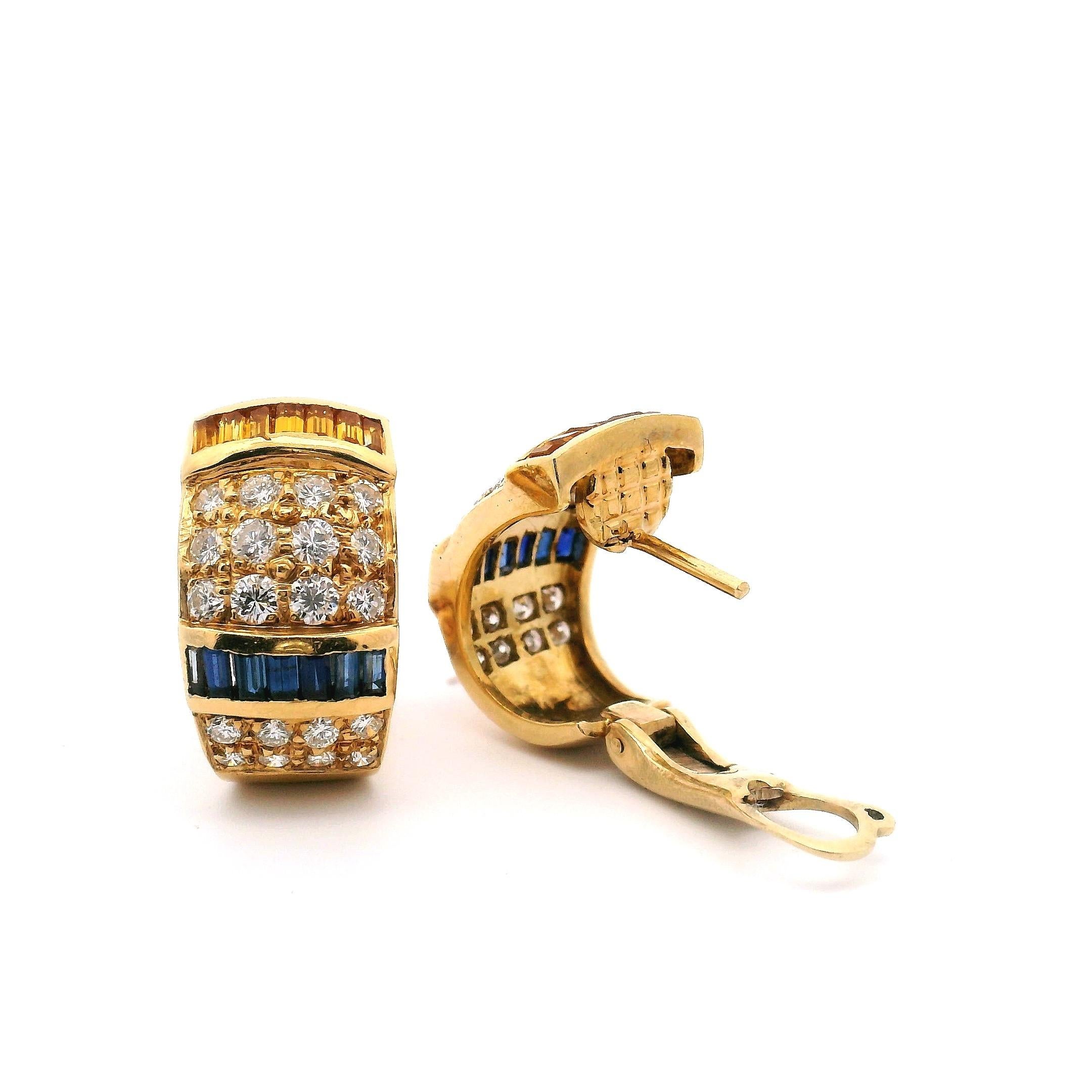One pair of 18kt. gold VCA huggie style earrings. 
consisting of:
20-Round brilliant cut diamonds 1.60cttw. Clarity VS1 Color F-G
14-sapphires seven yellow, seven blue 1.96cttw.
 
18k yellow gold 9.2 grams 


Gram weight is with set stones 
Set