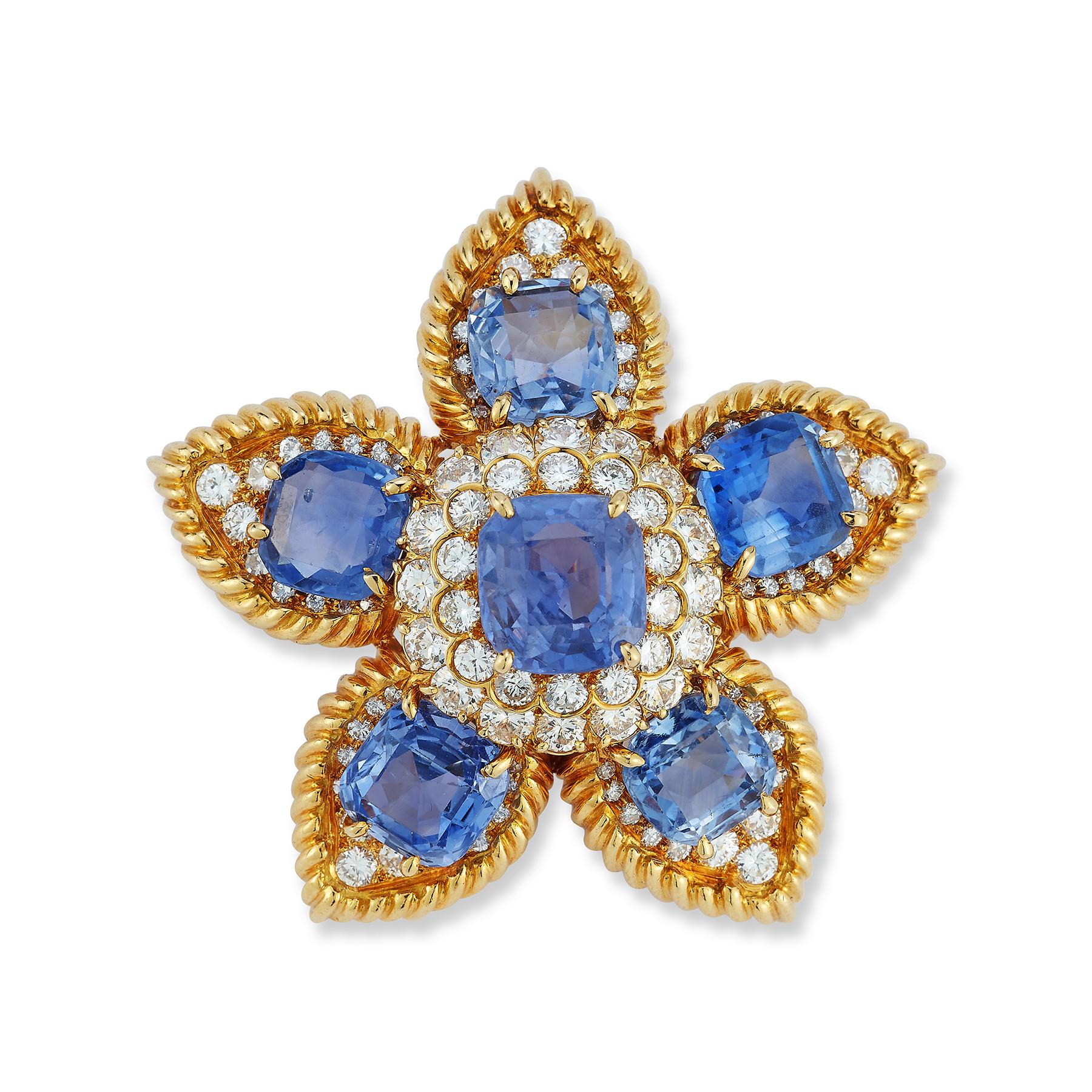 Van Cleef & Arpels Sapphire & Diamond Flower Brooch

1 larger cushion cut center natural Ceylon sapphire surrounded by 5 smaller cushion cut natural Ceylon sapphires weighing approximately 35-40 carats & set with round cut diamonds.

Accompanied by