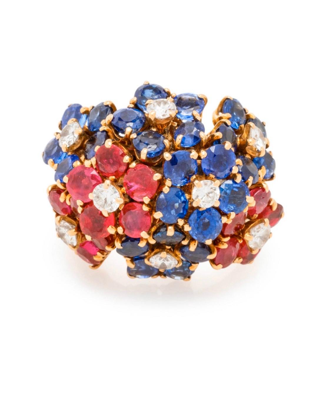 This multi-stone ring features 25 round mixed cut sapphires measuring approximately 3.42-3.95 mm in diameter, 15 round mixed cut rubies measuring approximately 2.30-3.16 mm in diameter and eight round brilliant cut diamonds weighing approximately