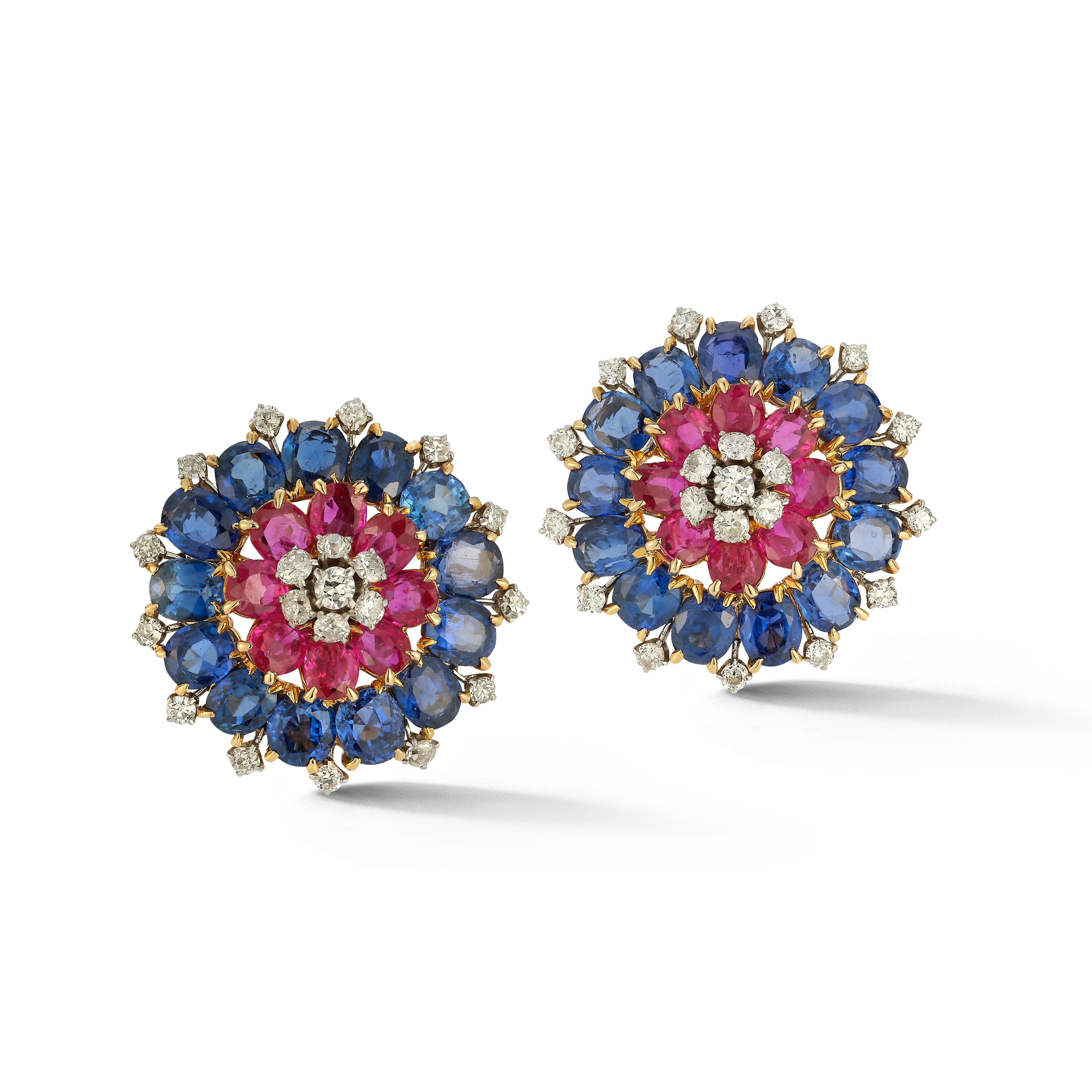 Van Cleef & Arpels Sapphire, Ruby & Diamond Earrings

Each earring consists of a central cluster of 7 round cut diamonds surrounded by an inner ring of 8 oval cut rubies and an outer ring of 13 oval cut sapphires accented by an additional 13 round