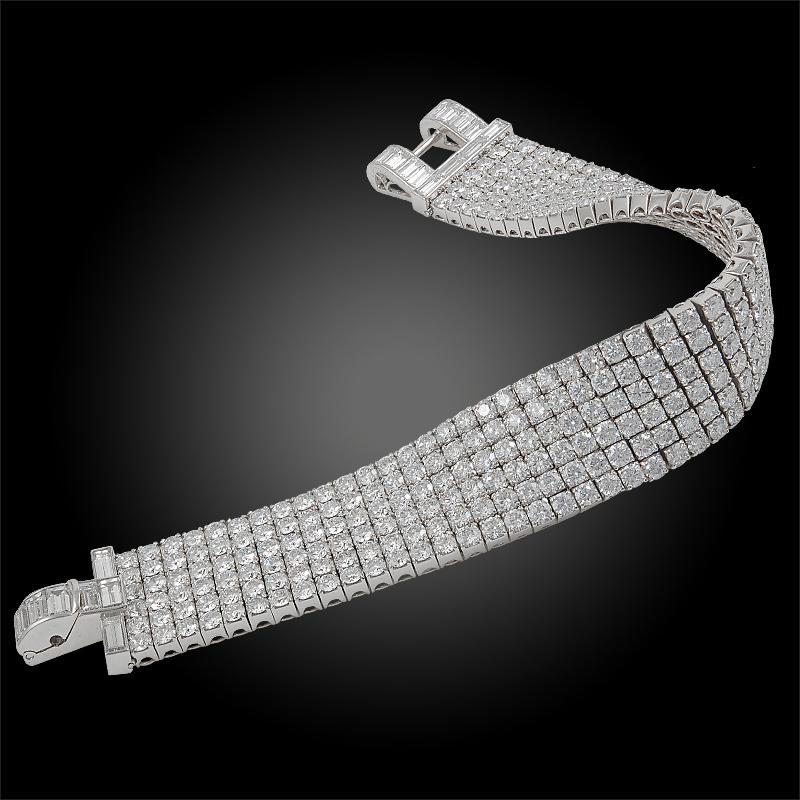 A glamorous six row diamond bracelet of flexible movement and design by Van Cleef & Arpels that dates back to the 1970s, crafted with an opulence of high quality diamonds weighing a total of 27.50 carats throughout, centering an exceptional baguette