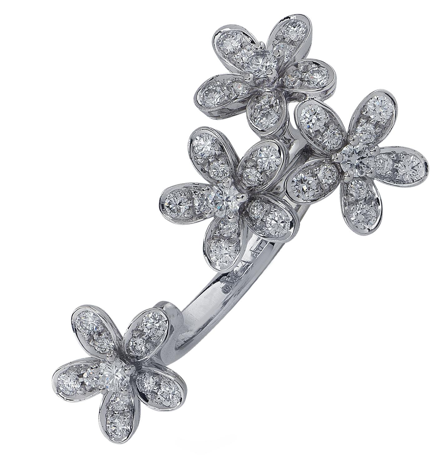 From the House of Van Cleef & Arpels, this exquisite Socrate Between the Finger ring, is finely handmade in 18 Karat white gold. Four diamond encrusted flowers are daintily arranged, capturing the unparalleled beauty of nature. This stunning piece