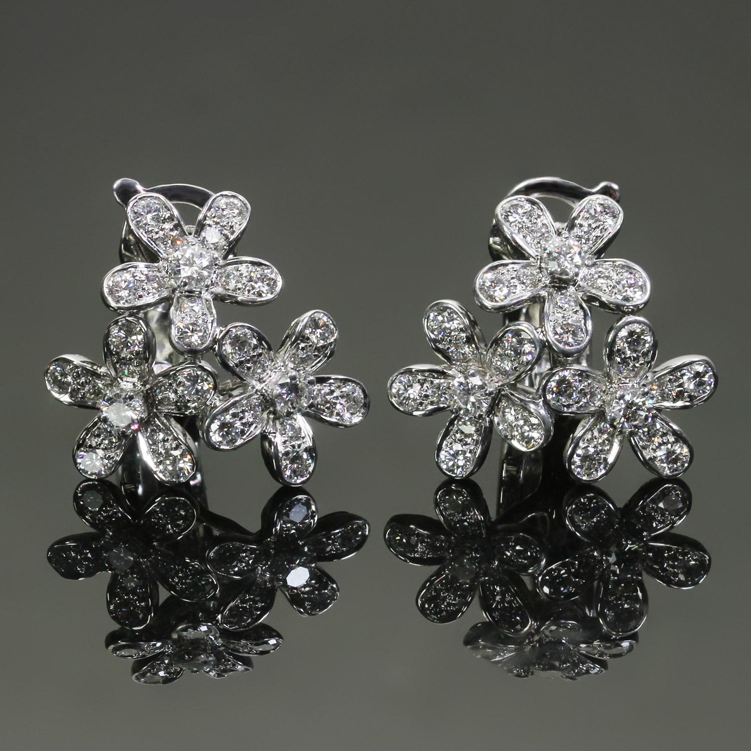 These exquisite earrings from the elegant Socrate collection by Van Cleef & Arpels are crafted in 18k white gold and feature a delicate 3-flower motif set with 66 brilliant-cut round D-E-F VVS1-VVS2 diamonds weighing an estimated 1.32 carats. Made