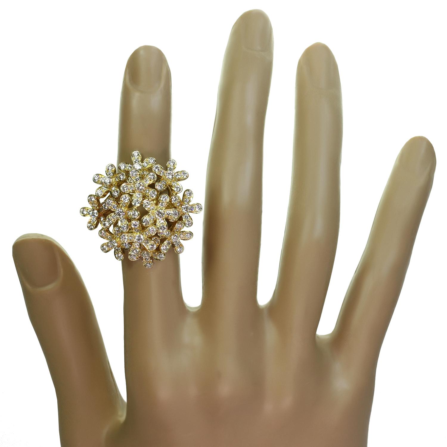 This dazzling Van Cleef & Arpels ring from the iconic Socrate collection features a delicate sparkling floral bouquet crafted in 18k yellow gold and set with 132 brilliant-cut round D-F VVS1-VVS2 diamonds weighing an estimated 3.00 carats. Made in