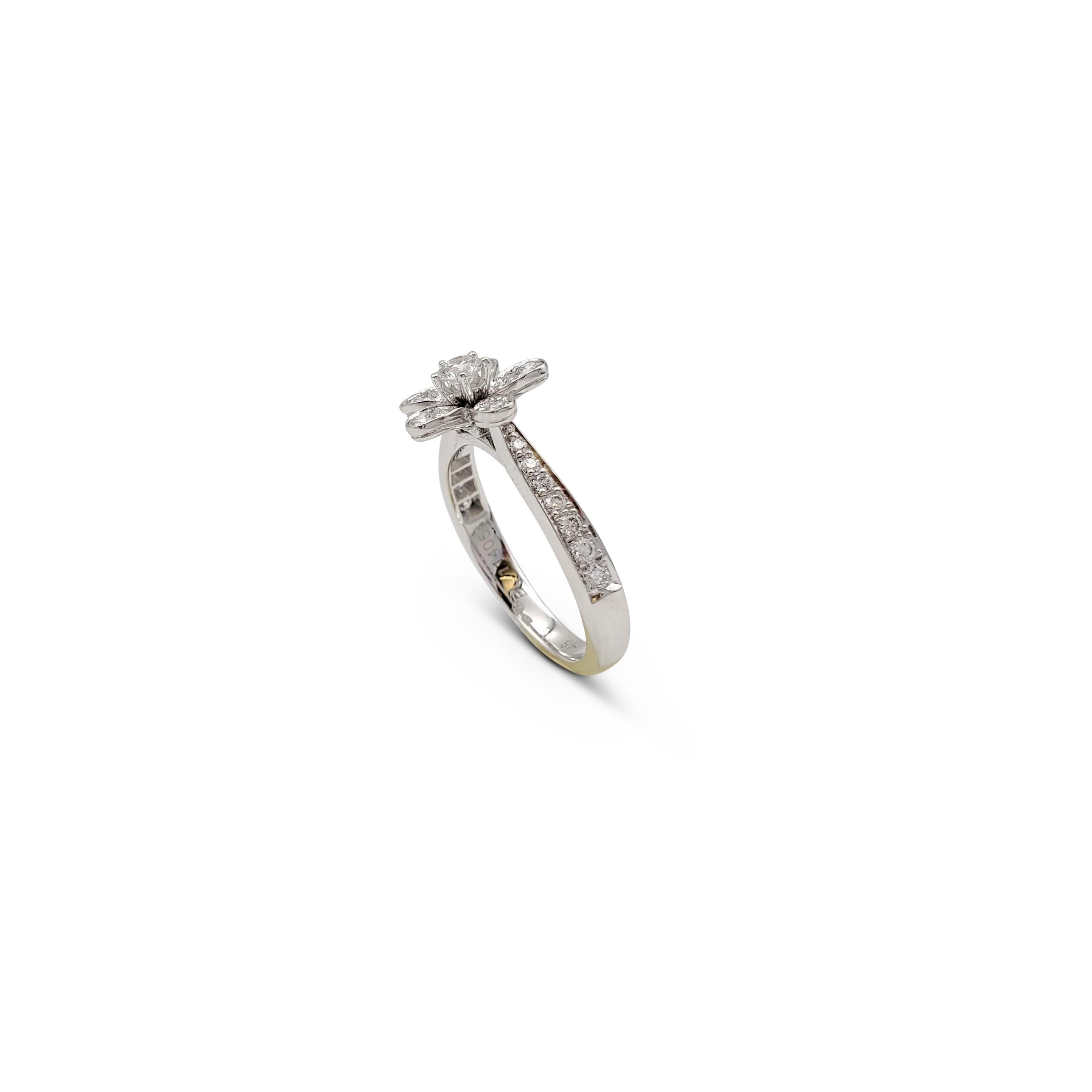 Authentic Van Cleef & Arpels 'Socrate' ring crafted in 18 karat white gold centers on a delicate single flower and is set with an estimated 0.45 carats of round brilliant cut diamonds (E-F, VS). Signed VCA, 750, 48, with serial number. The ring is
