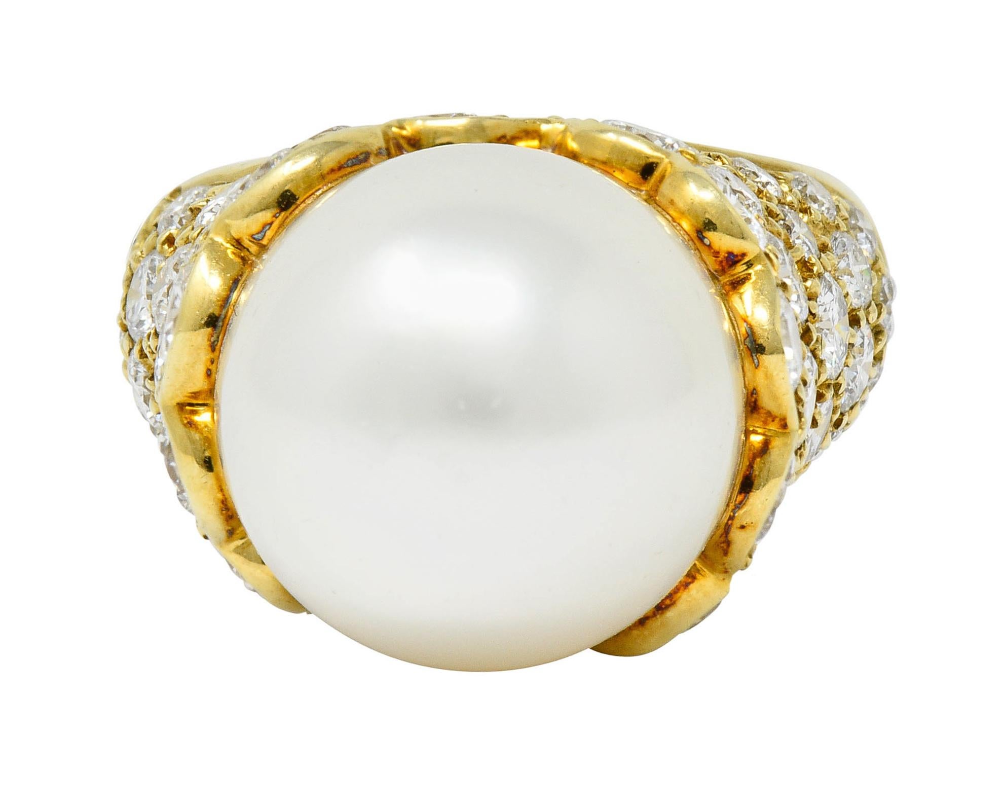 Centering a large 13.0 mm near round South Sea pearl

White in color with strong silvery overtones and subtle purple overtones, excellent in luster

Set in a pavè diamond mounting with an elegantly scalloped edge

Round brilliant cut diamonds weigh