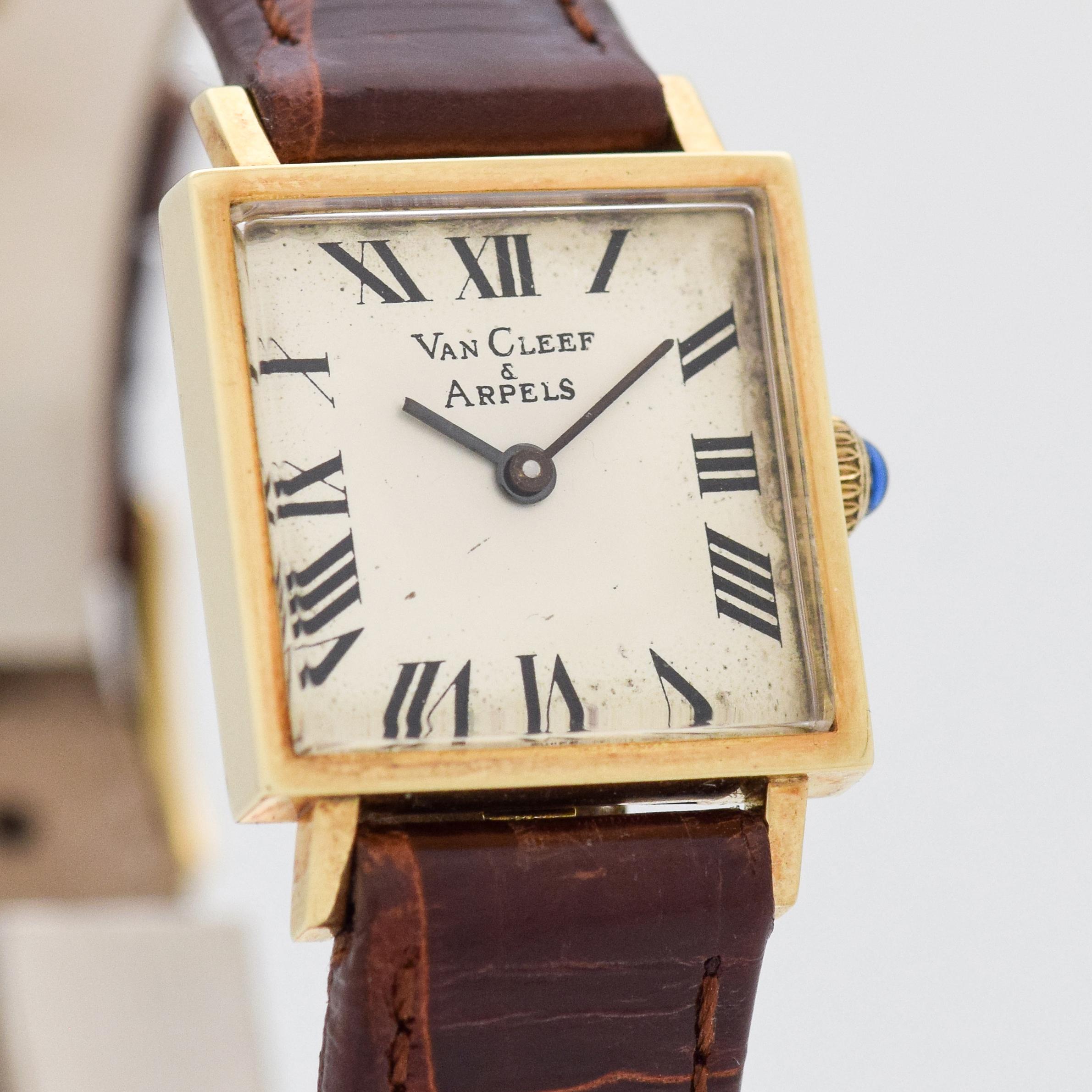 1990's Van Cleef & Arpels Ladies 14k Yellow Gold Square watch with Original Silver Dial with Black Painted Roman Numerals.  20mm x 28mm lug to lug (0.79 in. x 1.1 in.) - 17 jewel, manual caliber ETA movement. Triple Signed. Comes with Original Box.