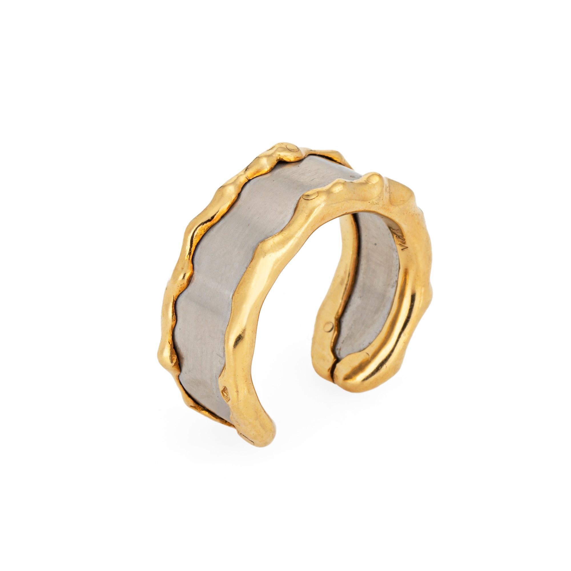 Vintage Van Cleef & Arpels steel & 18k yellow gold cuff ring (circa 1990s).  

The stylish cuff ring highlights a steel center bordered with an undulating 18k yellow gold design. The ring is great worn alone or stacked with your fine jewelry from