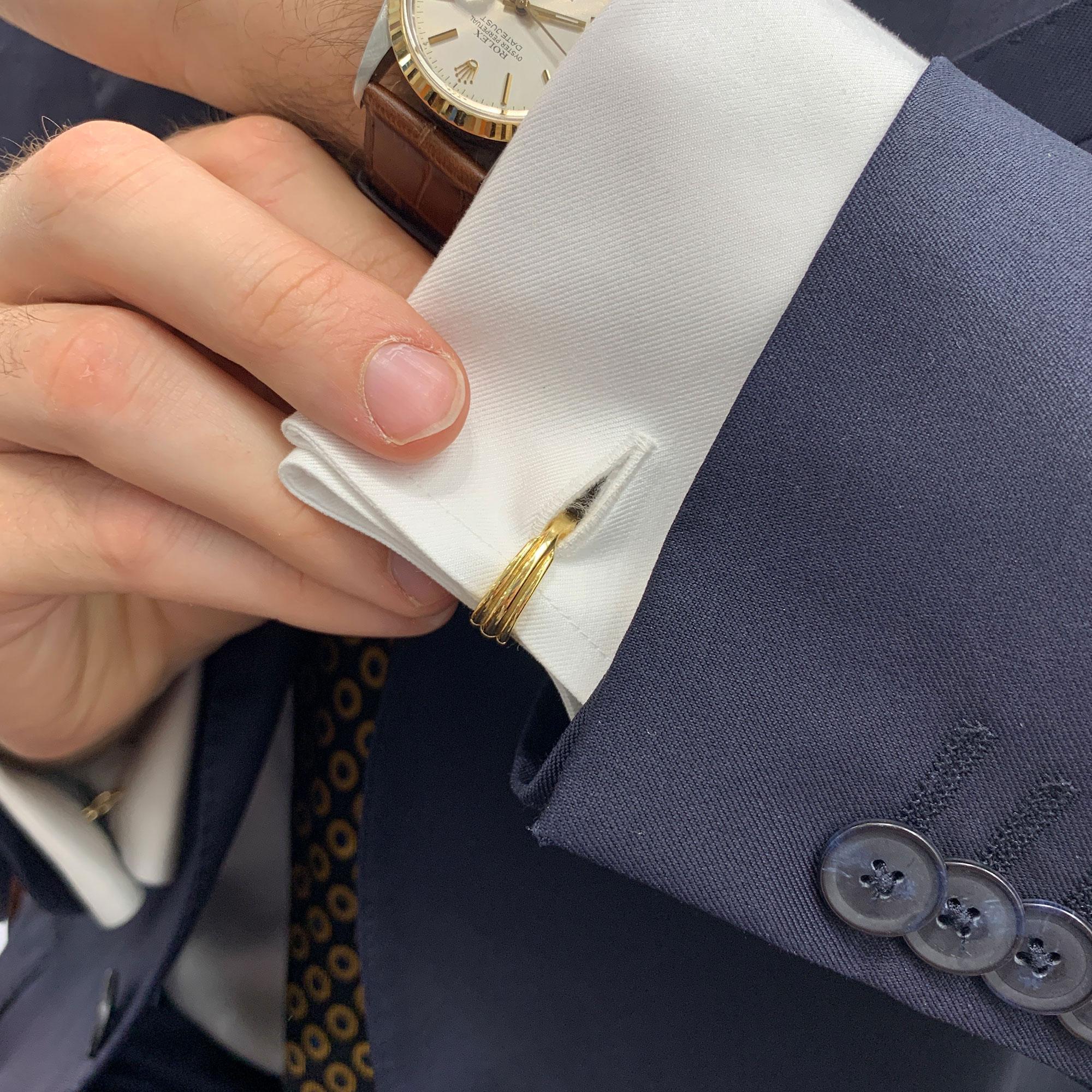 A stylish pair of Van Cleef & Arpels stirrup cufflinks in 18-karat yellow and white gold, circa 1960. Each cufflink is designed as a stirrup with ridged engraving, with a hinged click-shut system. Dimensions: 1.9x1.7cm.