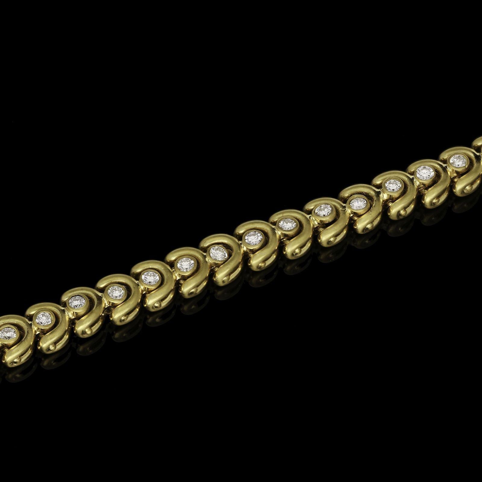 A beautifully supple vintage gold and diamond bracelet by Van Cleef & Arpels c.1955, the row of thirty-one uniform open links of semi-circular shape formed of brushed yellow gold and set with a round brilliant cut diamond in rub over setting, to a
