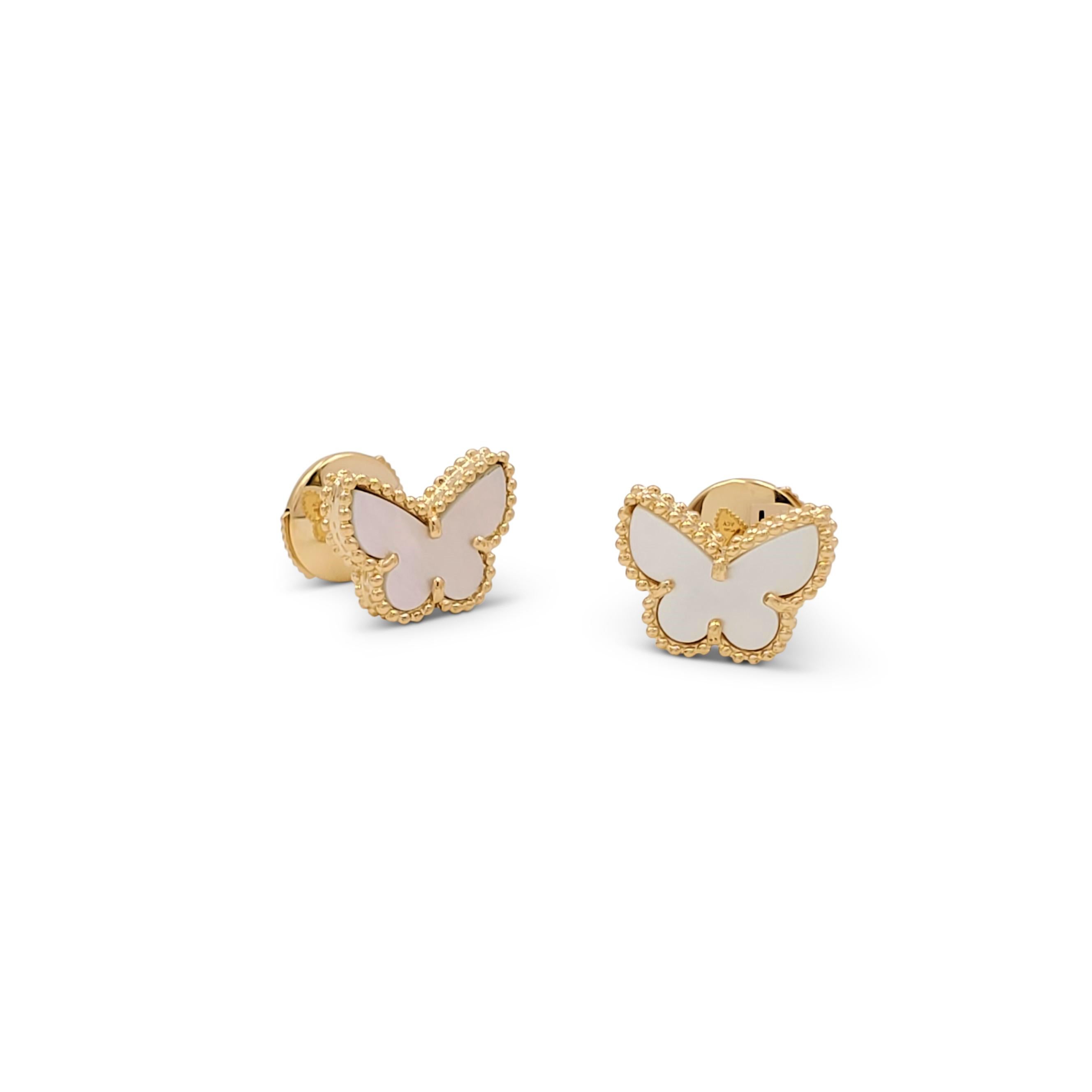 Authentic Van Cleef & Arpels 'Sweet Alhambra' earrings crafted in 18 karat yellow gold center on a pair of mother-of-pearl butterfly motifs. Signed VCA, Au750, with serial number. The earrings are presented with the original papers, no box. CIRCA