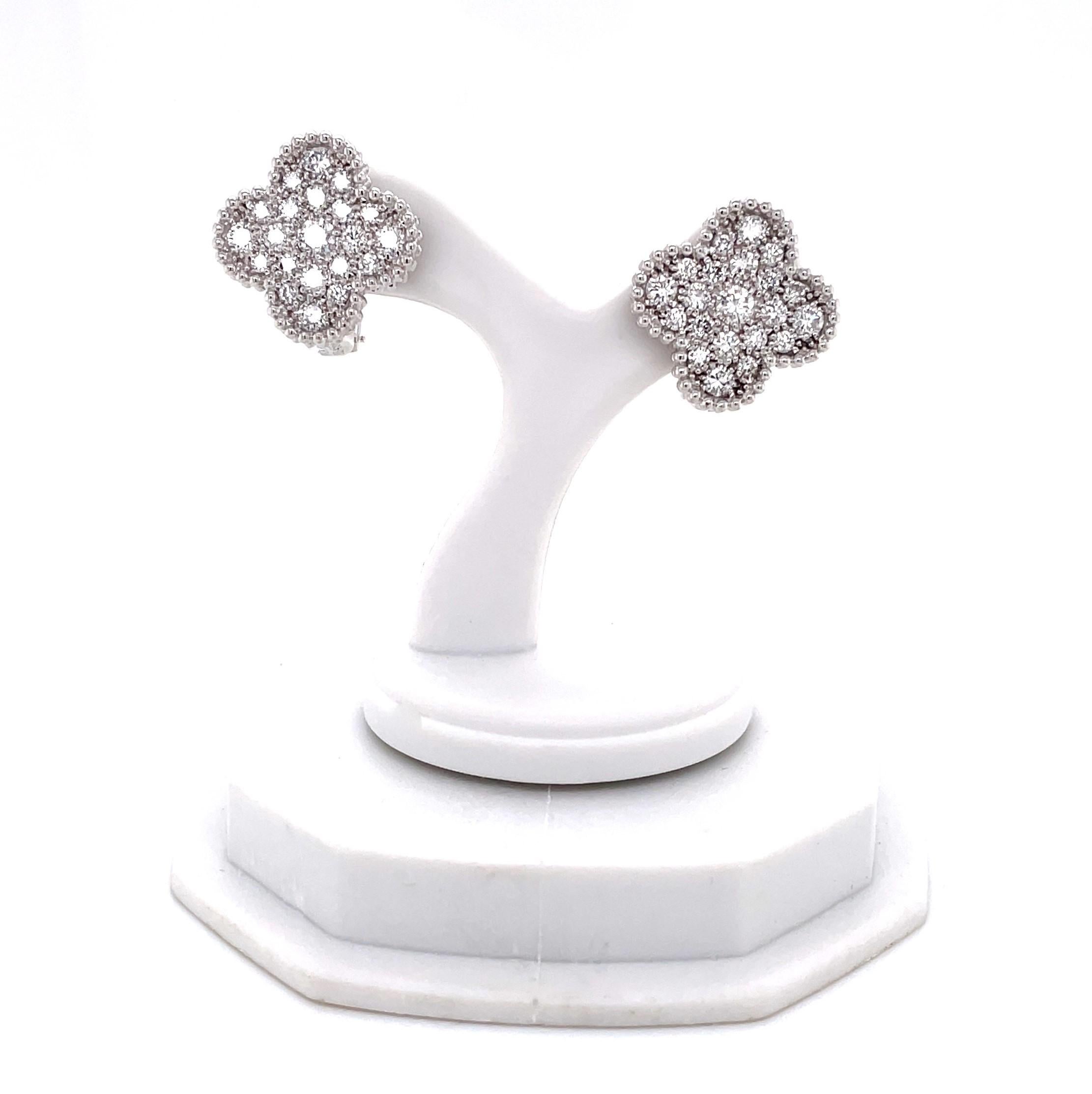 From the iconic Alhambra Collection by Van Cleef & Arpels, enjoy these four leaf clover inspired diamond VCA Alhambra Vintage Size Earring Studs in eighteen karat 18K white gold. Covered with 42 round faceted full cut white F/VS diamonds, the pair