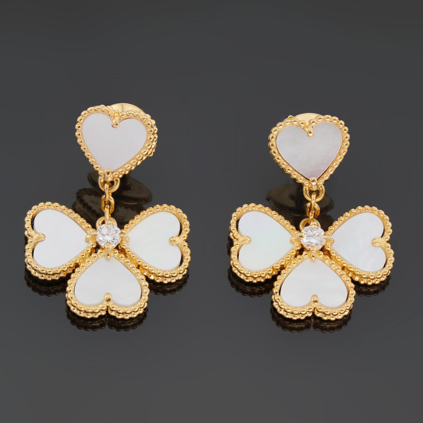 These stunning Van Cleef & Arpels earrings from the Sweet Alhambra Effeuillage collection feature a heart-motif and an alhambra drop motif crafted in 18k yellow gold and inlaid with Mother-of-Pearl and accented with round brilliant D-E-F VVS1-VVS2