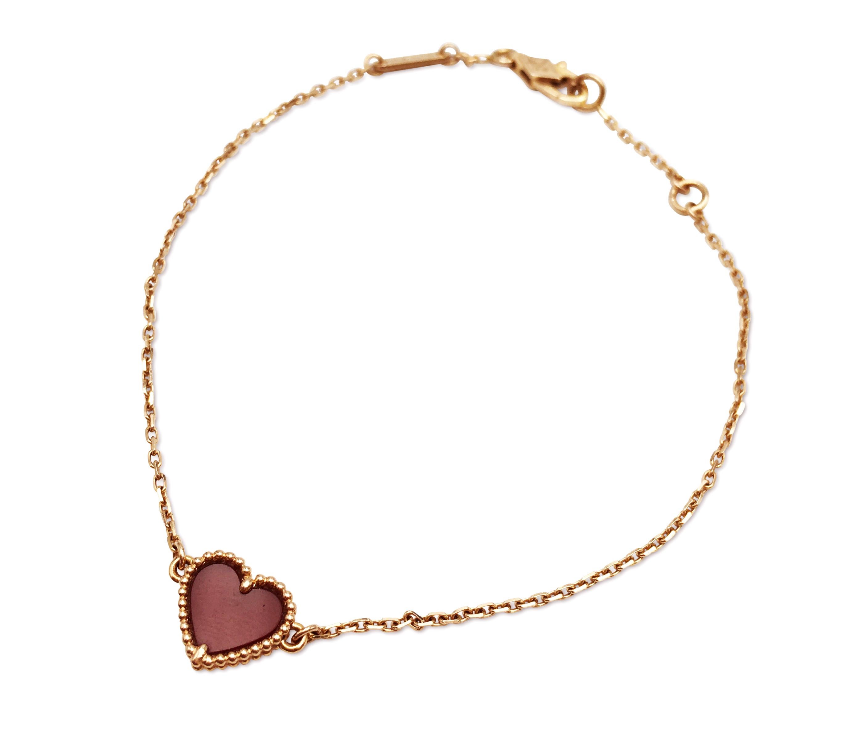 Authentic Van Cleef & Arpels 'Sweet Alhambra Heart' bracelet crafted in 18 karat rose gold features a single carnelian heart motif. Signed VCA, 750, with serial number. The bracelet is not presented with the original box or papers. CIRCA 2010s. 